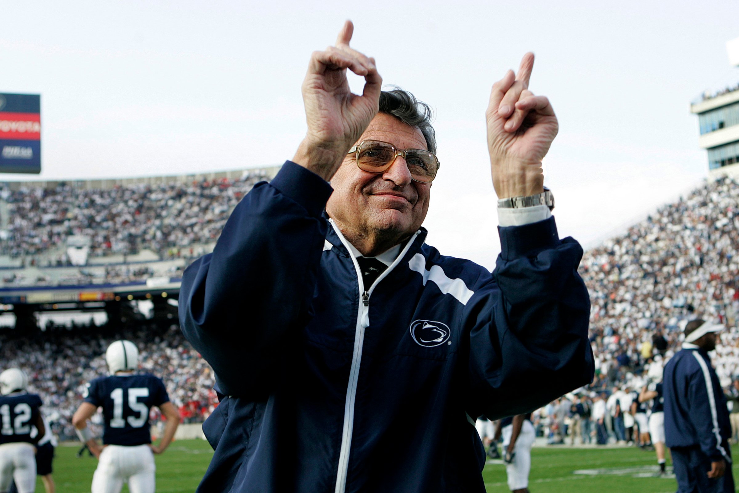 Penn State football coach Joe Paterno acknowledges the crowd before an NCAA college football game against Wisconsin in State College, Pa. on Nov. 5, 2005.
