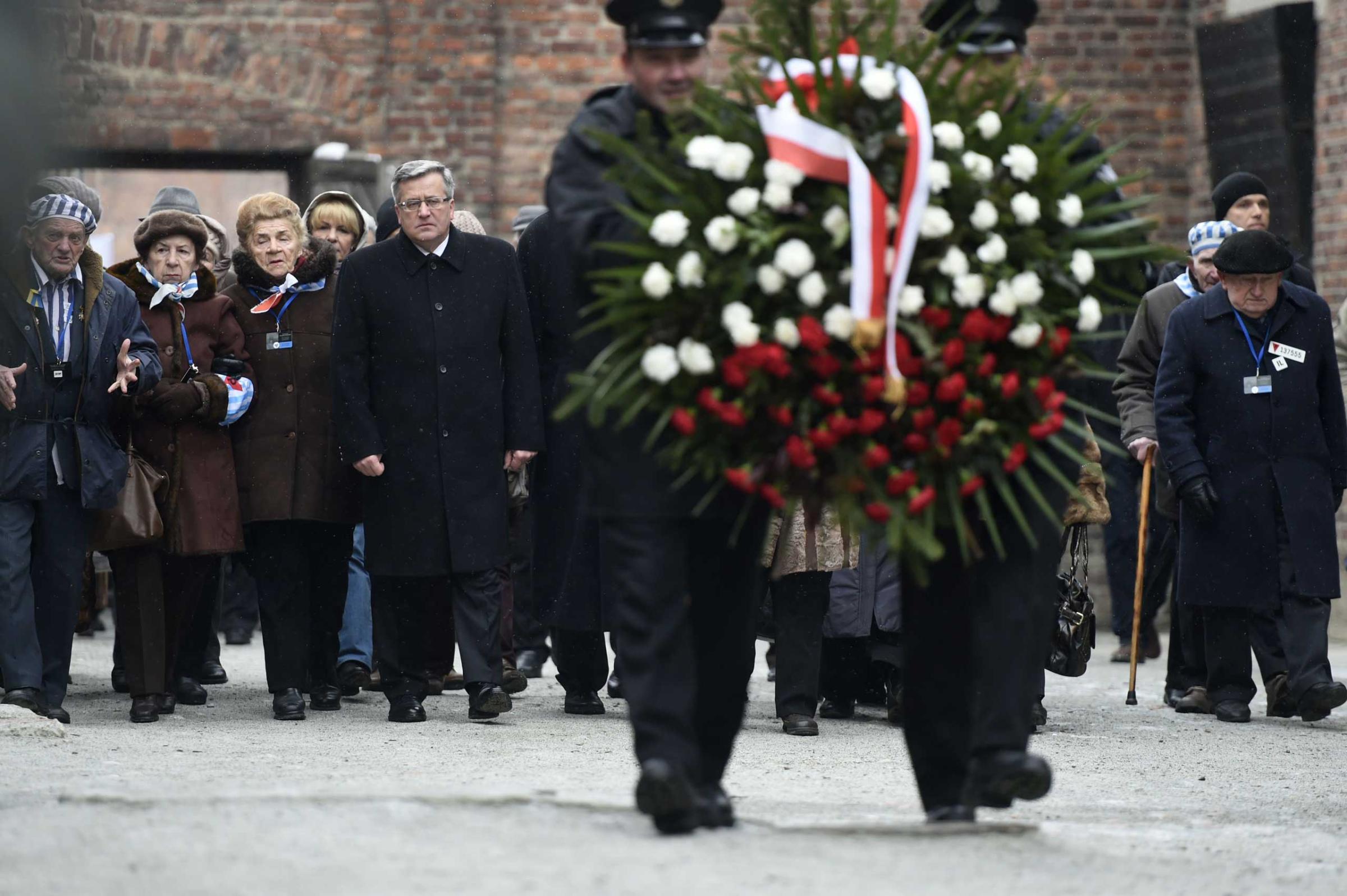 Polish President Bronislaw Komorowski and Auschwitz survivors lay down a wreath at the death wall of the former Auschwitz concentration camp on Jan. 27, 2015 at the Auschwitz-Birkenau memorial site in Oswiecim.