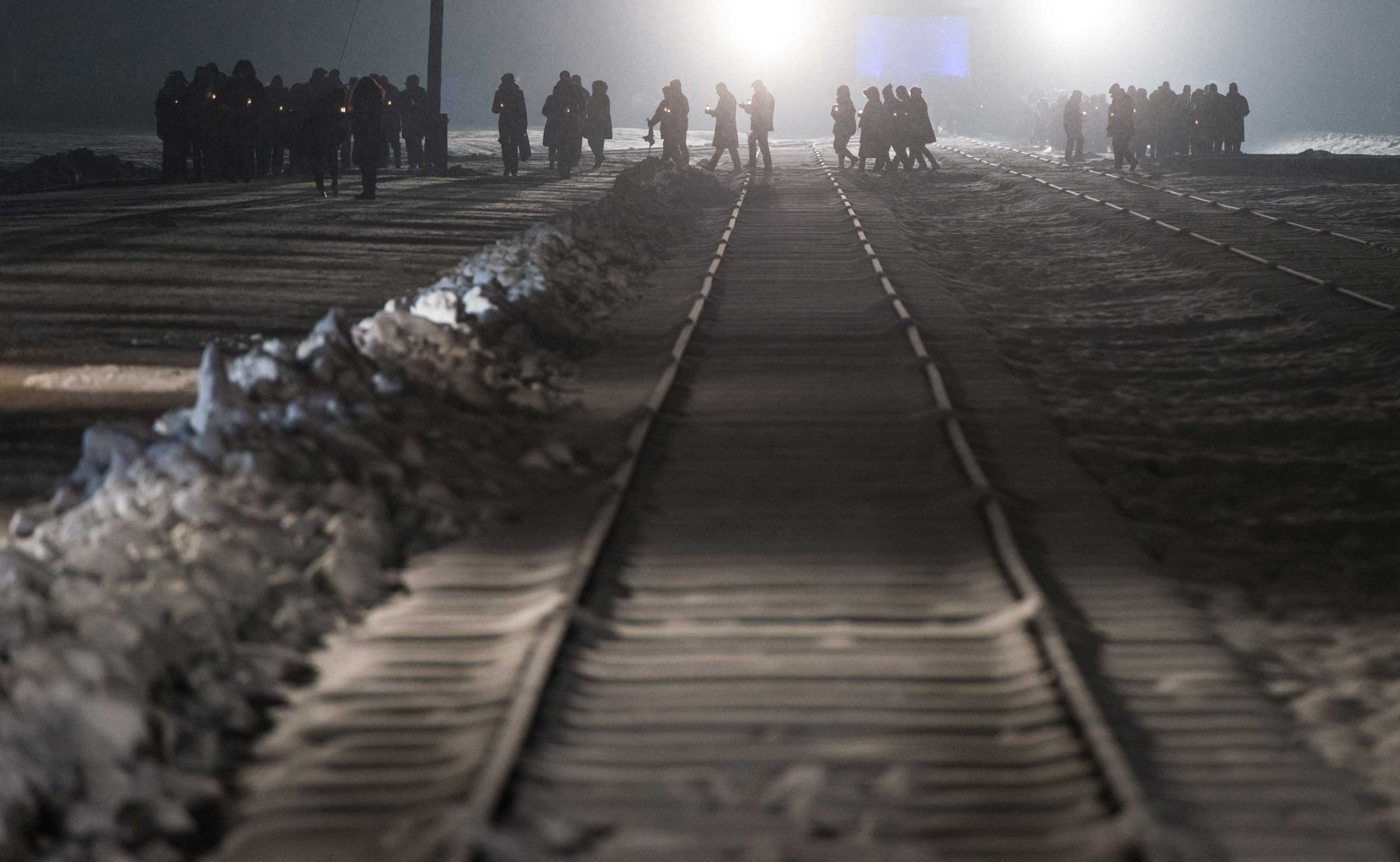 Auschwitz survivors and families visit the Birkenau Memorial carrying candles on Jan. 27, 2015 in Oswiecim, Poland.