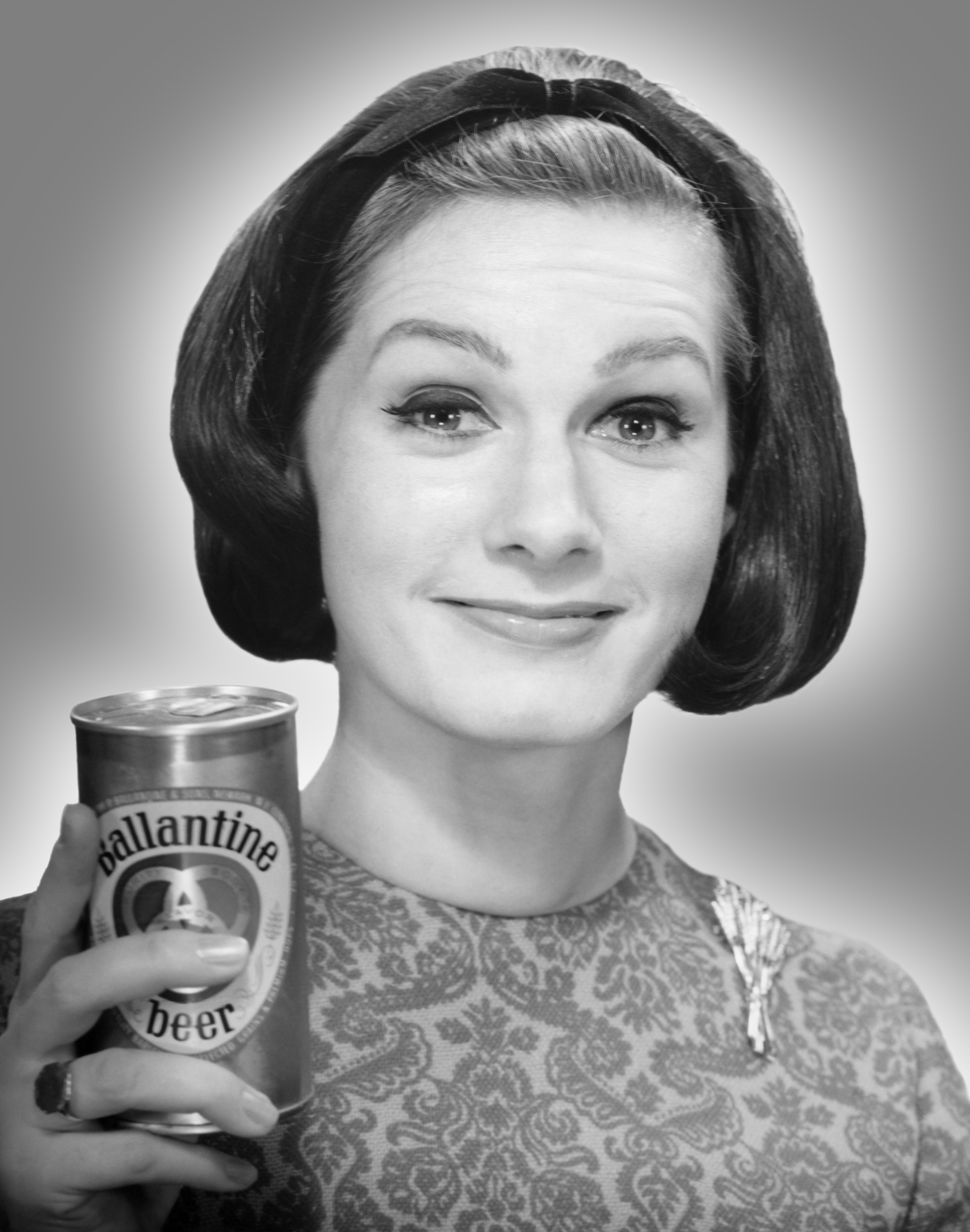 Woman holding can of beer