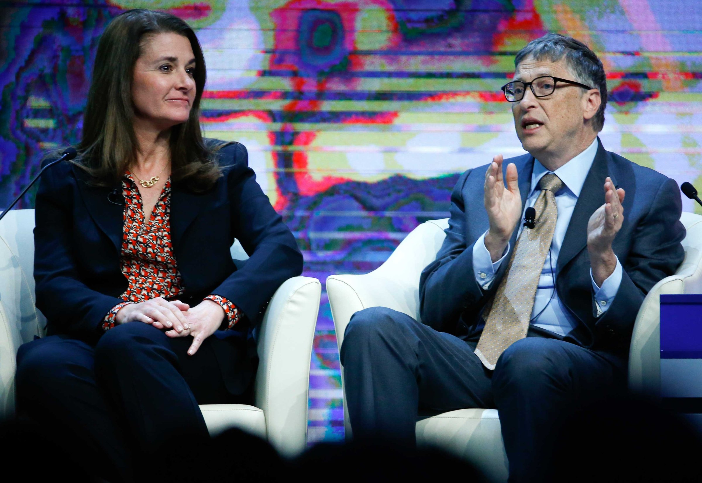Bill Gates, Co-Chair of the Bill & Melinda Gates Foundation gestures next to his wife Melinda French Gates during the session 'Sustainable Development: A Vision for the Future' in the Swiss mountain resort of Davos