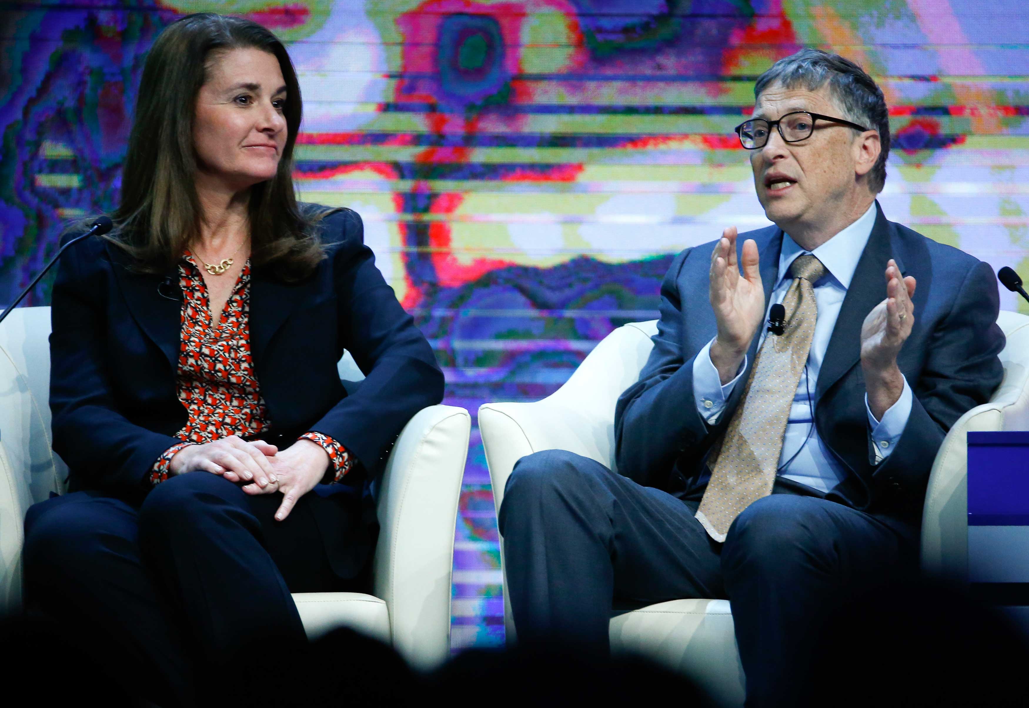 Bill Gates, Co-Chair of the Bill &amp; Melinda Gates Foundation gestures next to his wife Melinda French Gates during the session 'Sustainable Development: A Vision for the Future' in the Swiss mountain resort of Davos