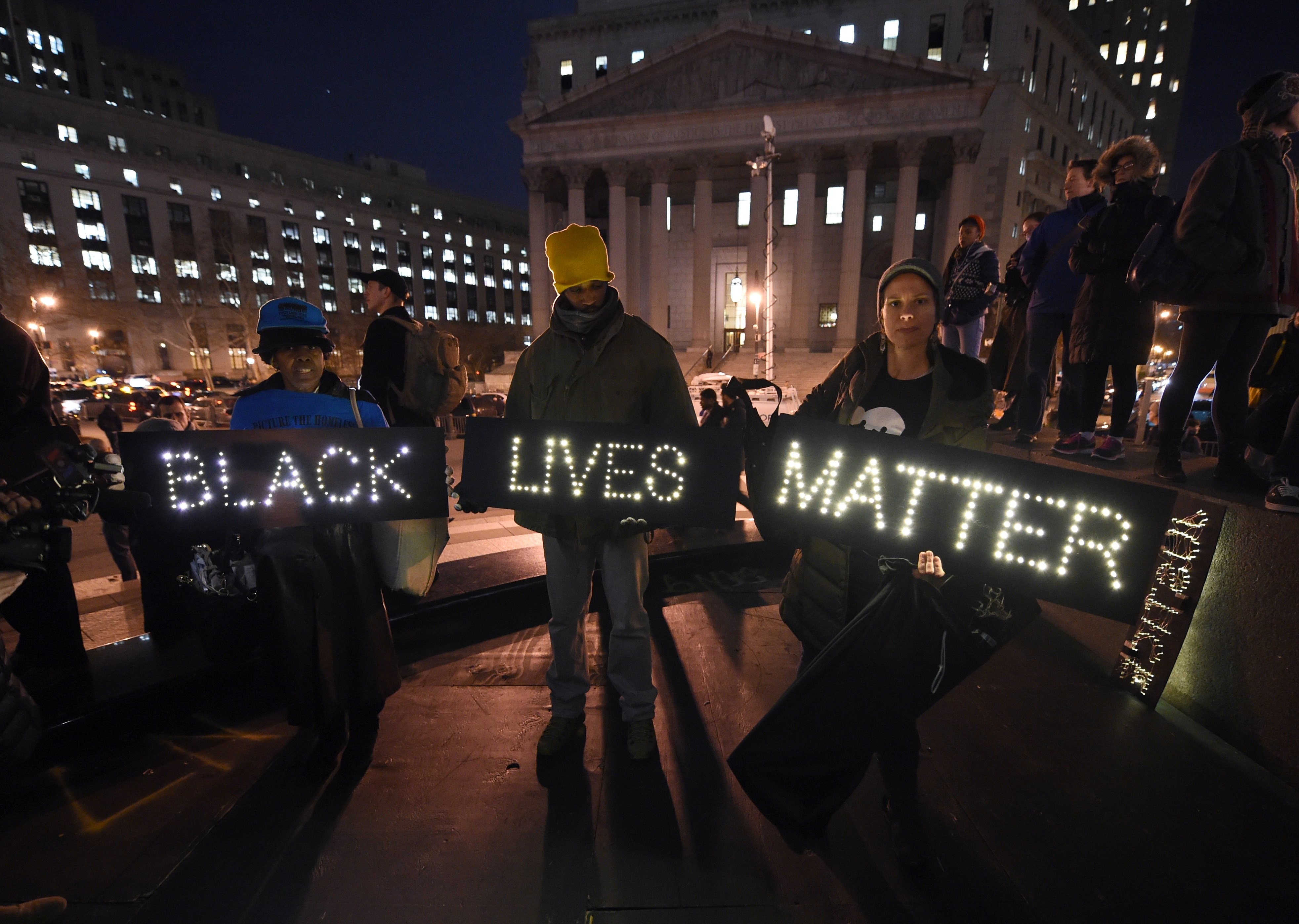 Protesters stand during a demonstration against the chokehold death of Eric Garner in Foley Square in New York City on Dec. 4, 2014. (Timothy A. Clary—AFP/Getty Images)