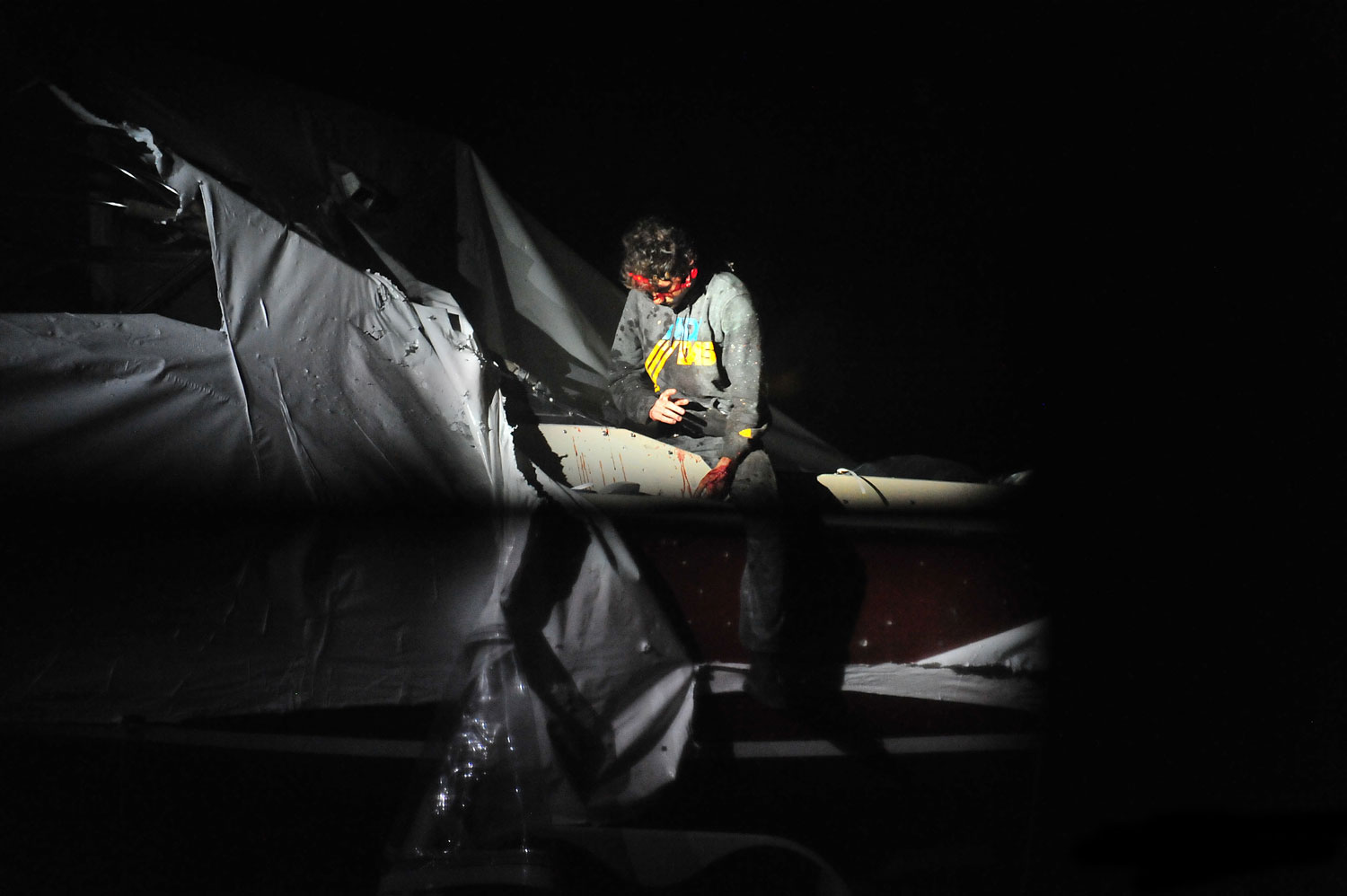 7:33:54 p.m. Tsarnaev begins to step out of the boat.