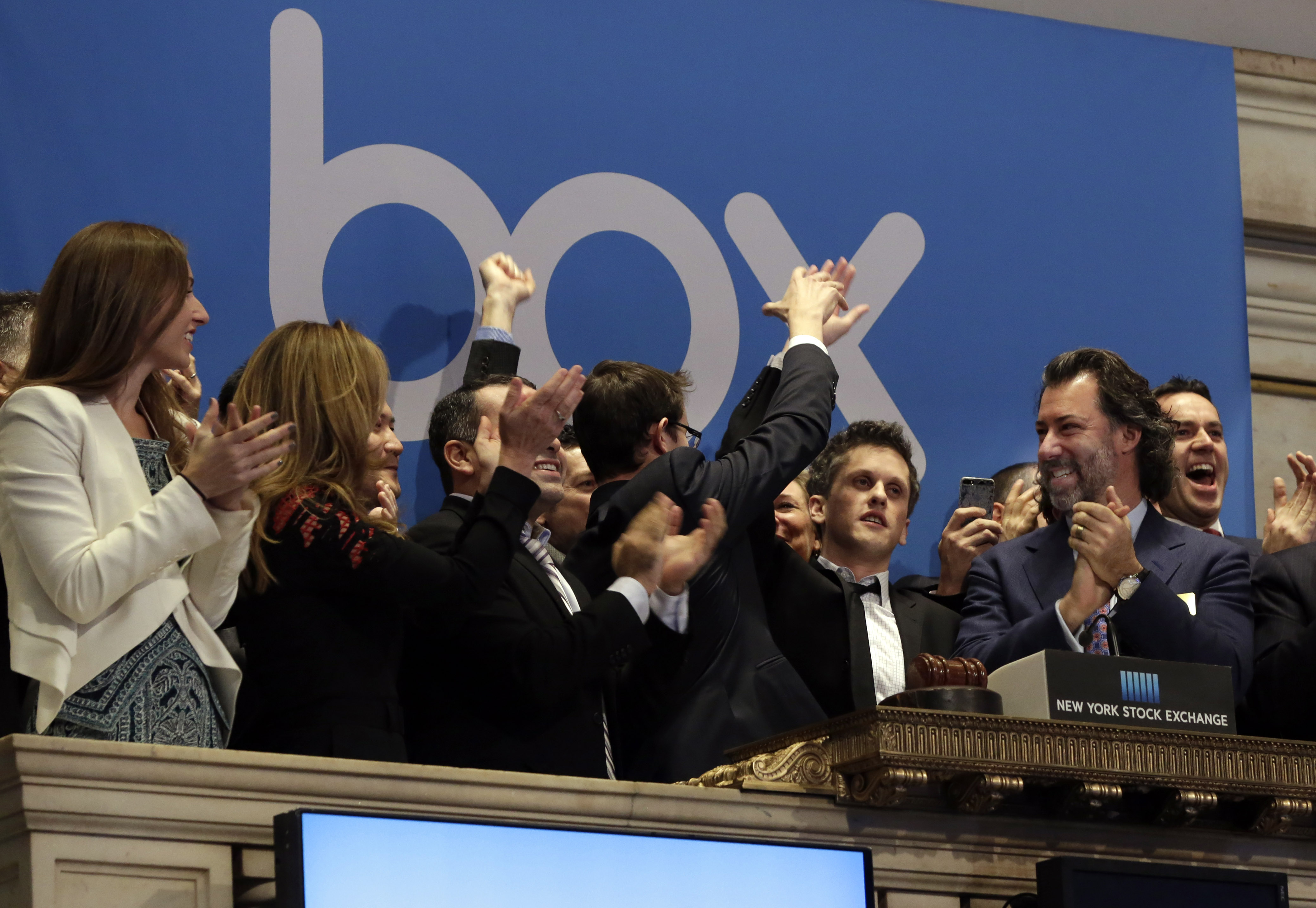 Box, Inc. Chairman, CEO &amp; co-founder Aaron Levie, second from right, gets a high-five during opening bell ceremonies to mark the company's IPO at the New York Stock Exchange on Jan. 23, 2015. (Richard Drew—AP)