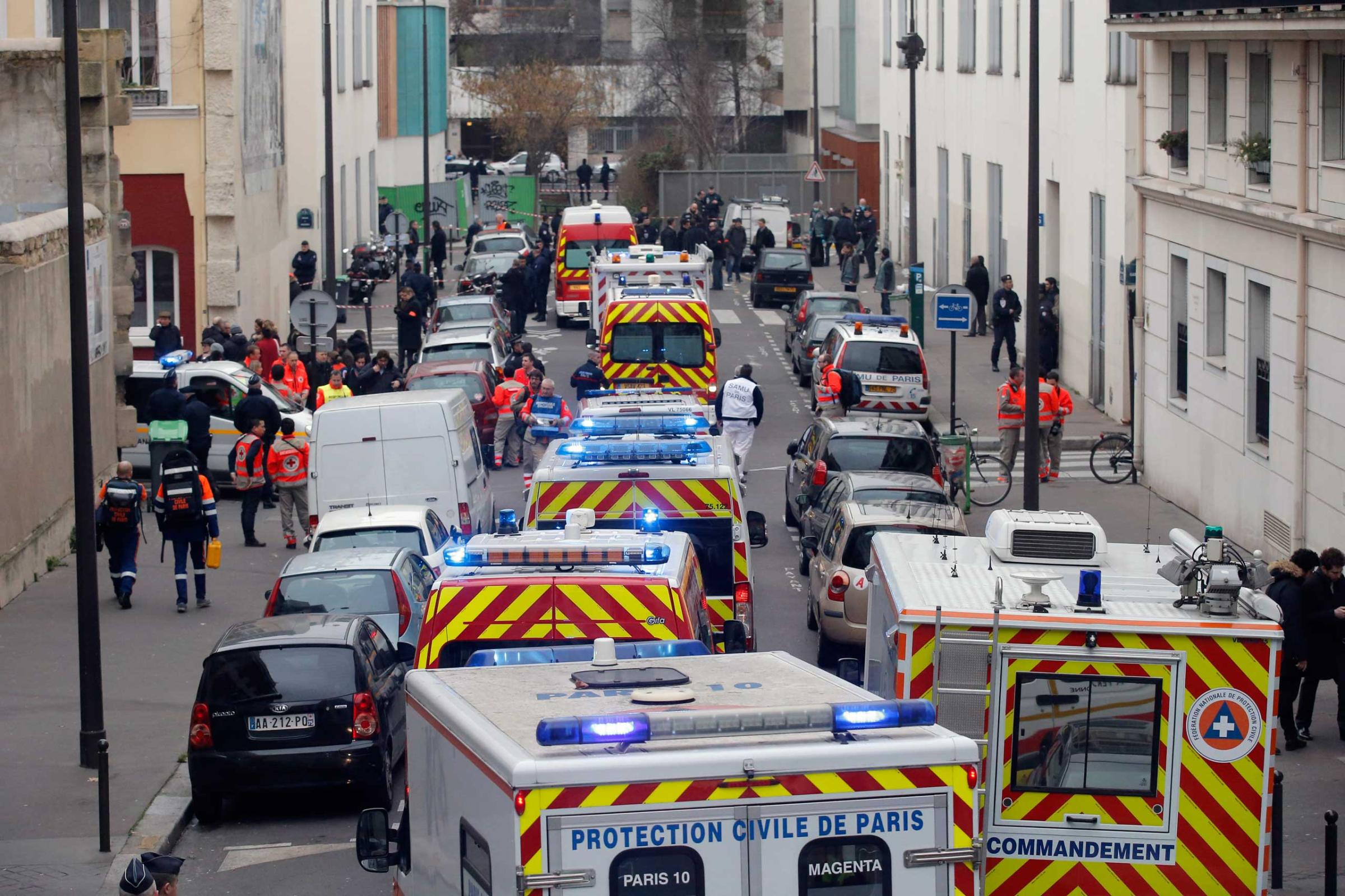 Ambulances gather in the street outside the French satirical newspaper Charlie Hebdo's office, in Paris, Jan. 7, 2015.