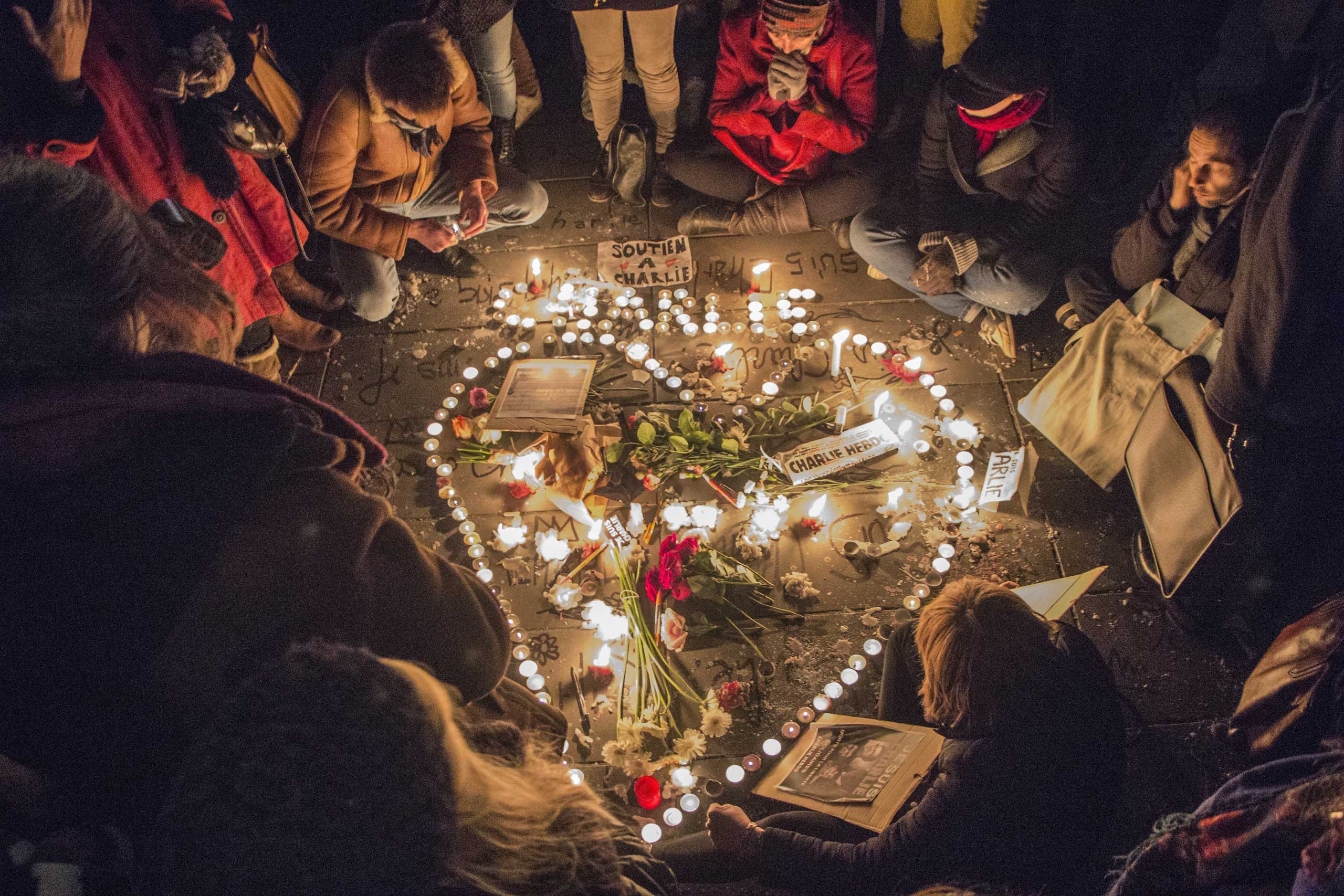 A tribute of flowers and candles in the shape of a heart is set up at Place de la Republique in Paris in memory of the victims of the Charlie Hebdo terrorist attack, on Jan. 7, 2015 in Paris.