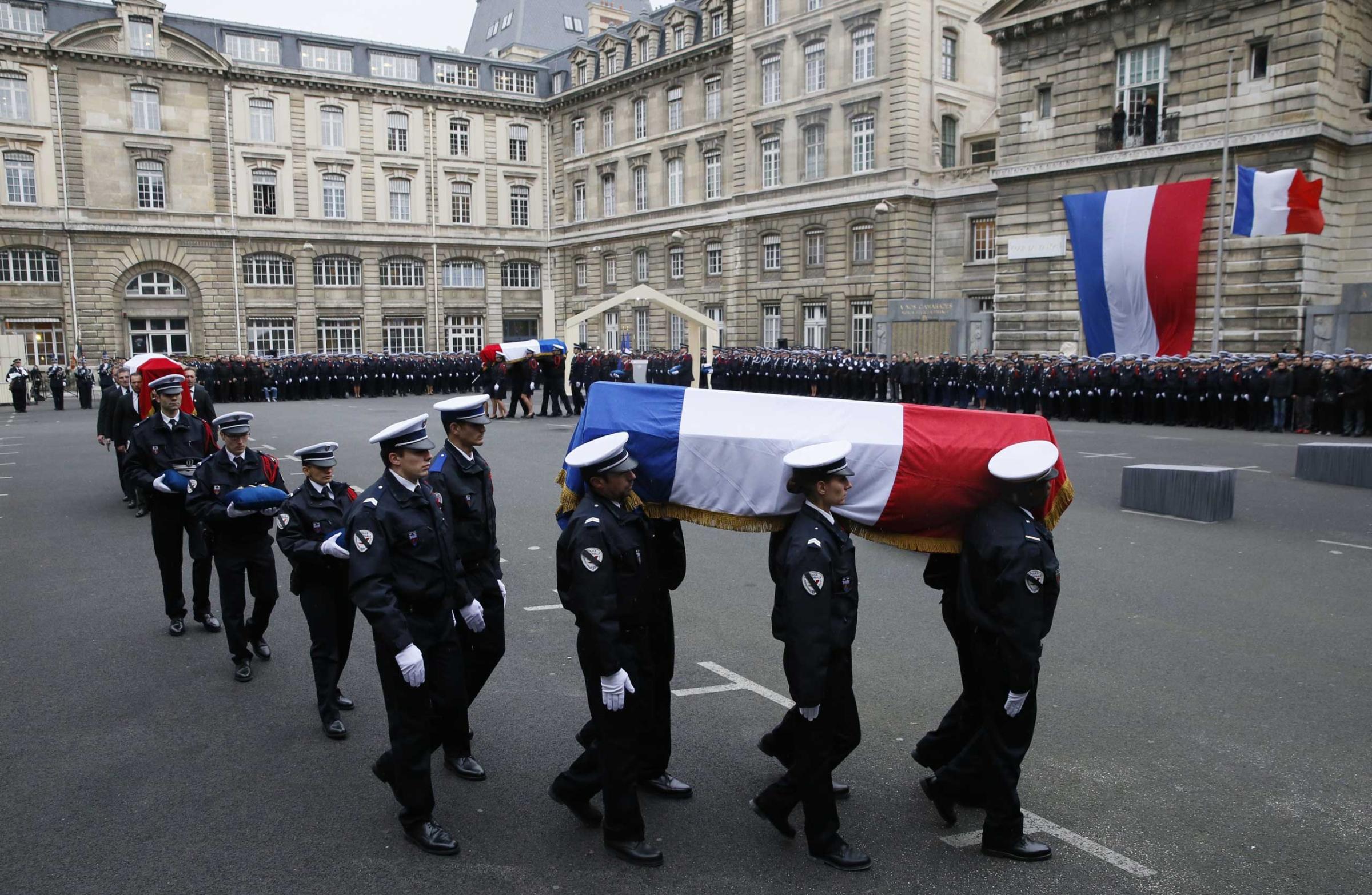 Police officers carry the coffins draped in the French flag of the three police officers killed in the recent Islamist attacks in a ceremony to posthumously decorate them with the Légion d’Honneur at the Invalides in Paris, on Jan. 13, 2015.