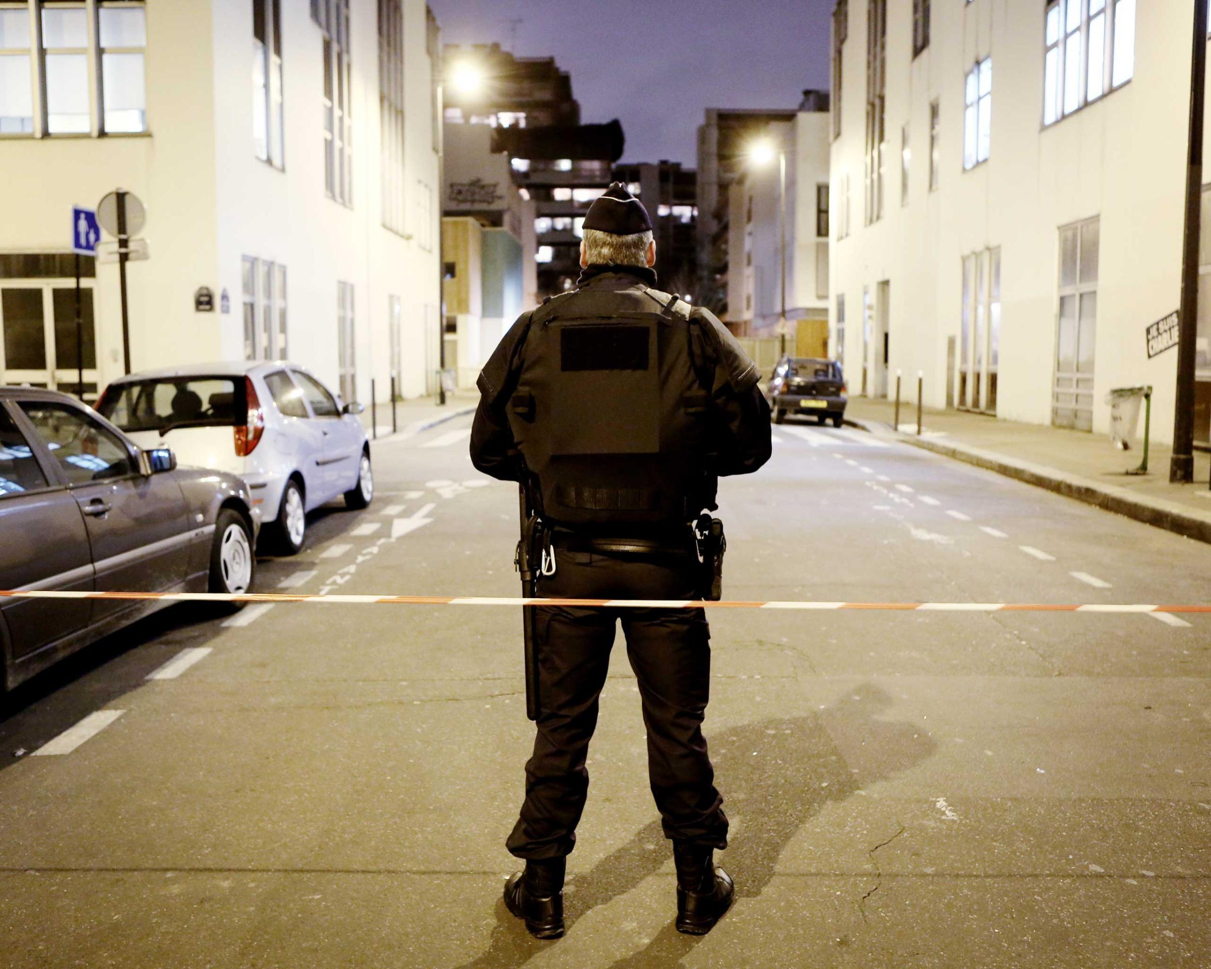 Police guard the area near the Charlie Hebdo offices, as Paris remains on alert after the killings, Jan. 12, 2015.