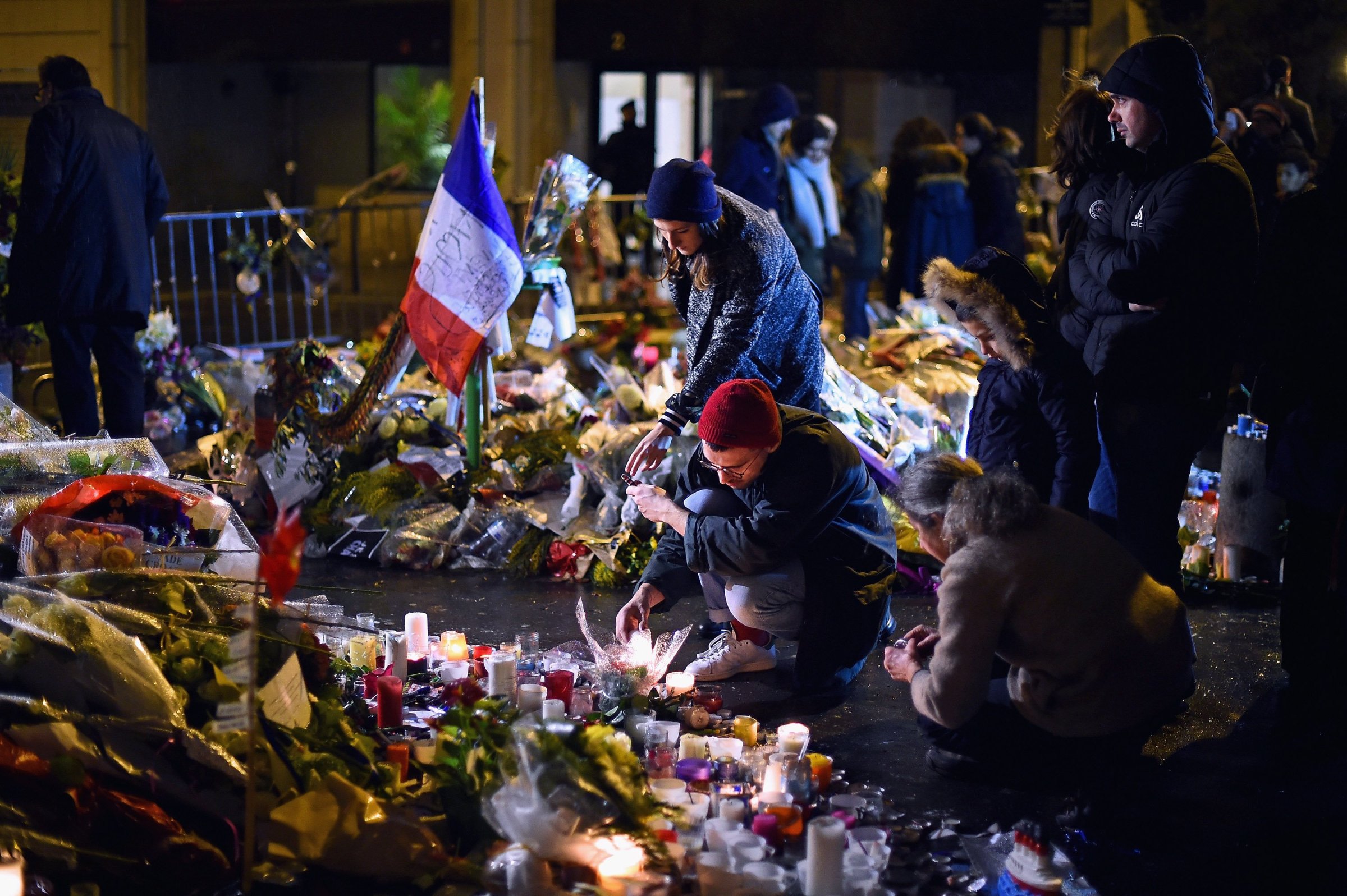 People light candles in tribute near the offices of French satirical magazine Charlie Hebdo on Jan. 10, 2015 in Paris.