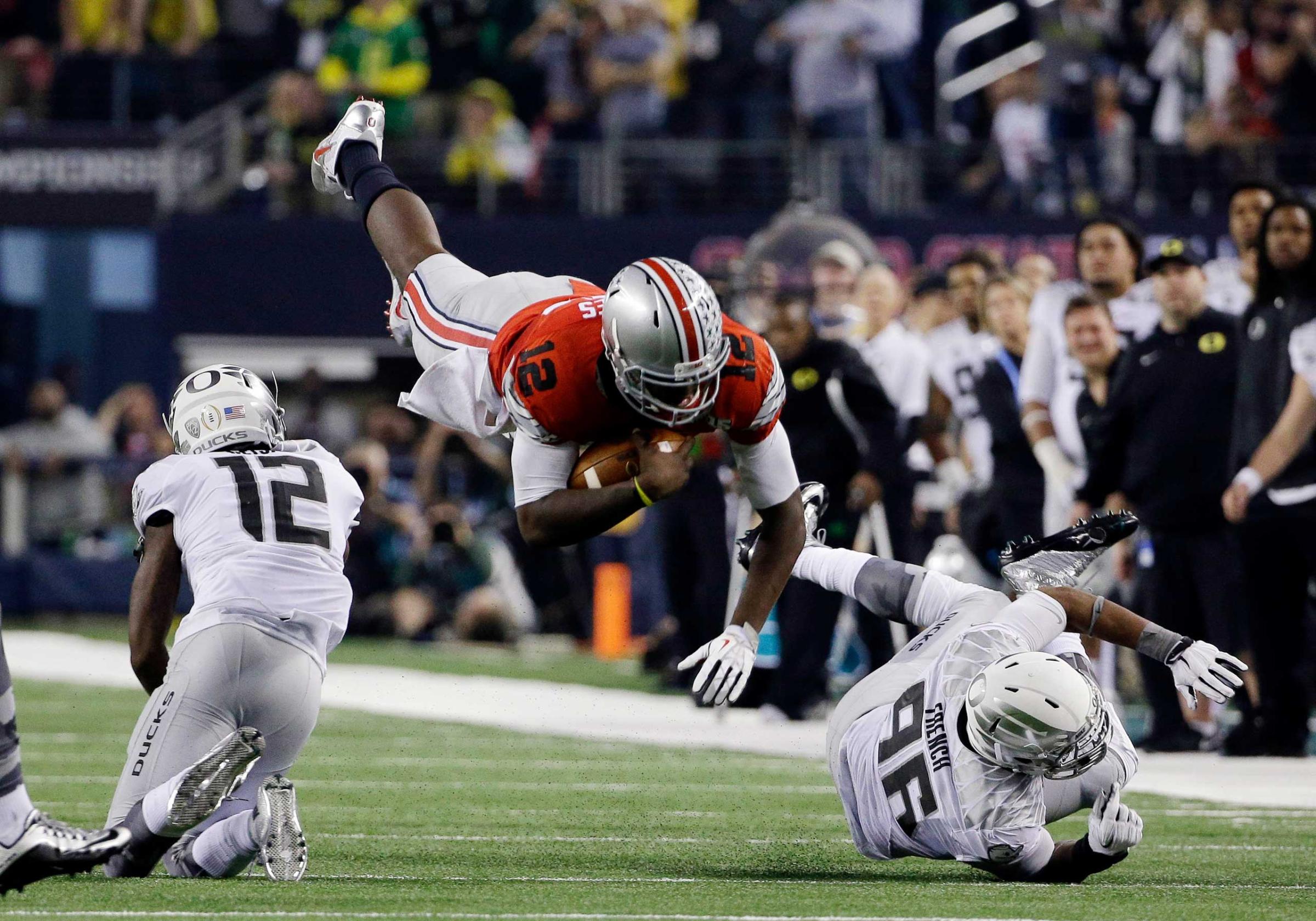 Ohio State's Cardale Jones (12) dives for a first down during the second half of the NCAA college football playoff championship game against Oregon on Jan. 12, 2015, in Arlington, Texas.