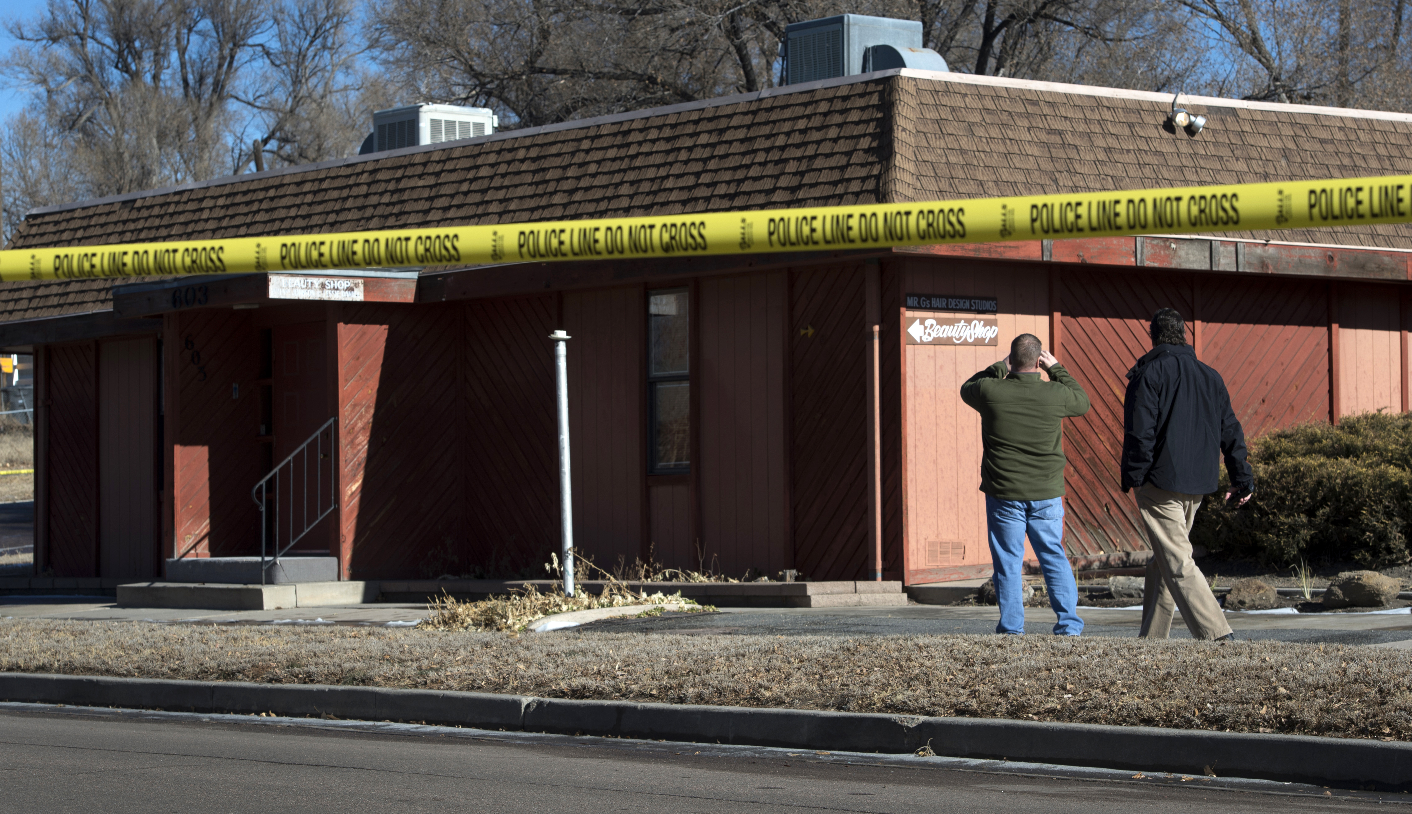 Colorado Springs police officers investigate the scene of an explosion on Jan. 6, 2015, at a building in Colorado Springs, Colo.