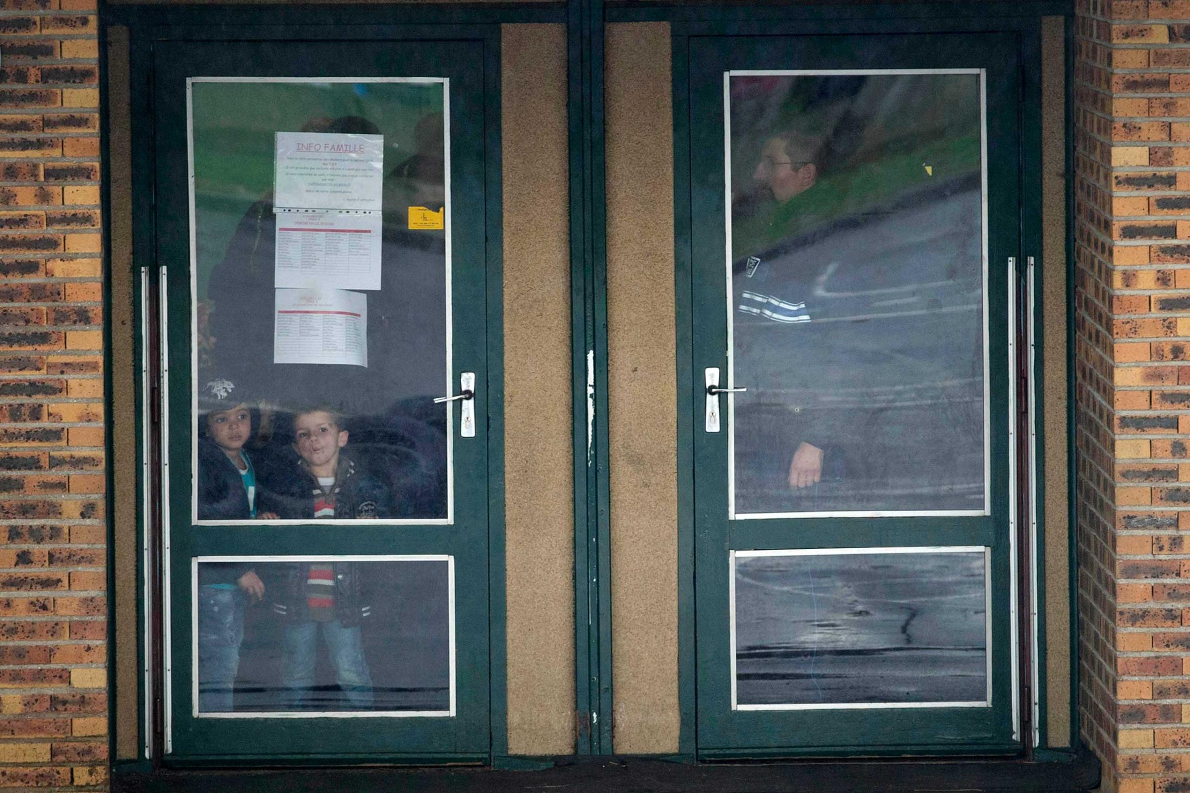 Children wait inside the Henri Dunand school before being moved to a safe location to be picked up by their parents in Dammartin-en-Goele, northeast of Paris, France, Jan. 9, 2015.