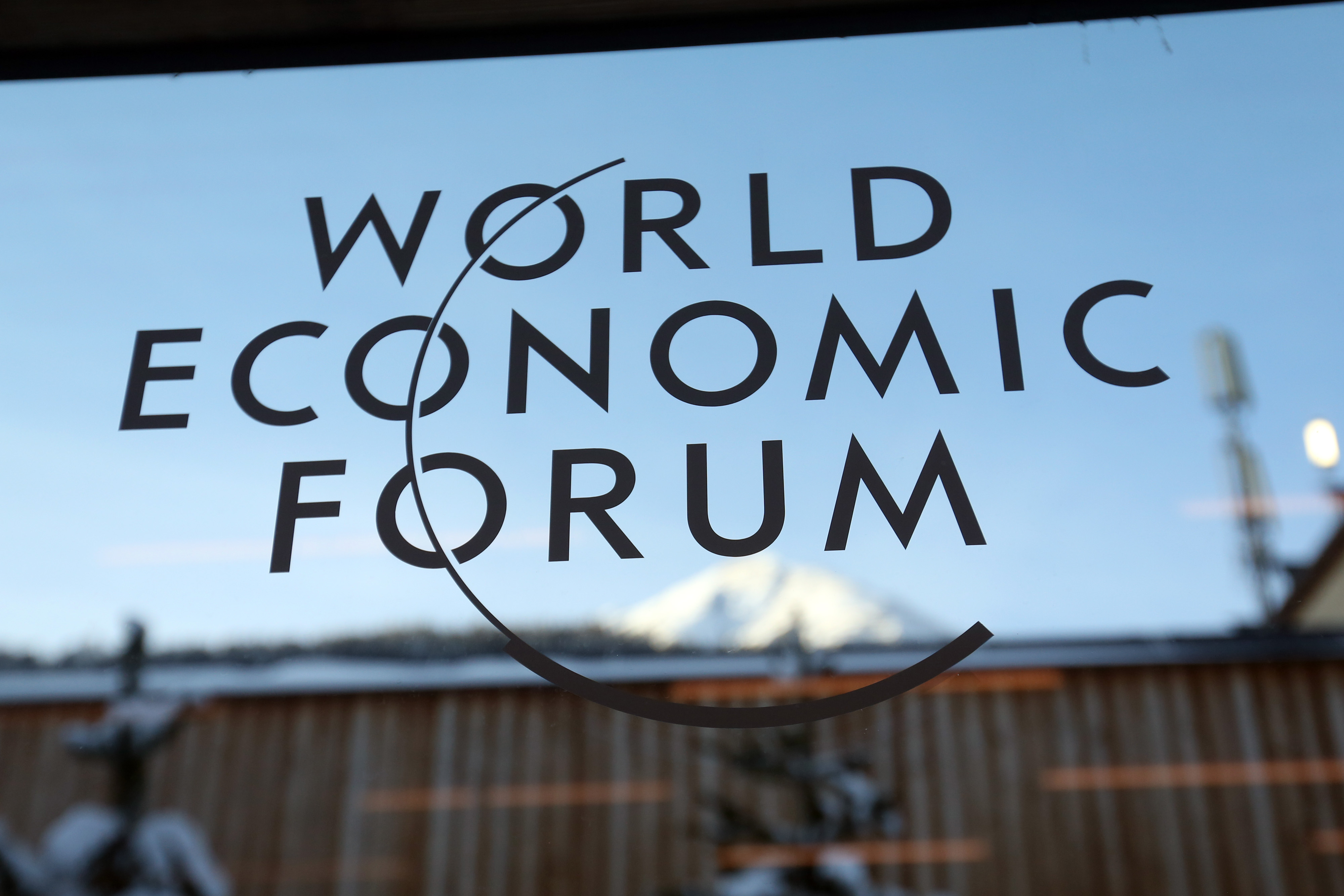 A logo sits on a glass panel inside the venue of the World Economic Forum (WEF) in Davos, Switzerland on Jan. 19, 2015.