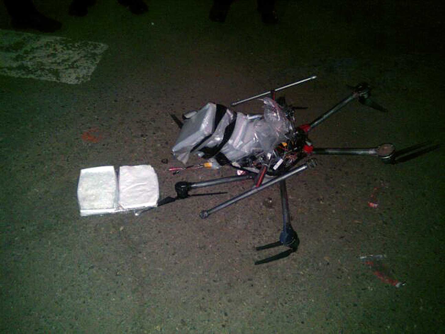 A drone loaded with packages containing methamphetamine lies on the ground after it crashed into a supermarket parking lot in the Mexican city of Tijuana on Jan. 20, 2015 (AP)
