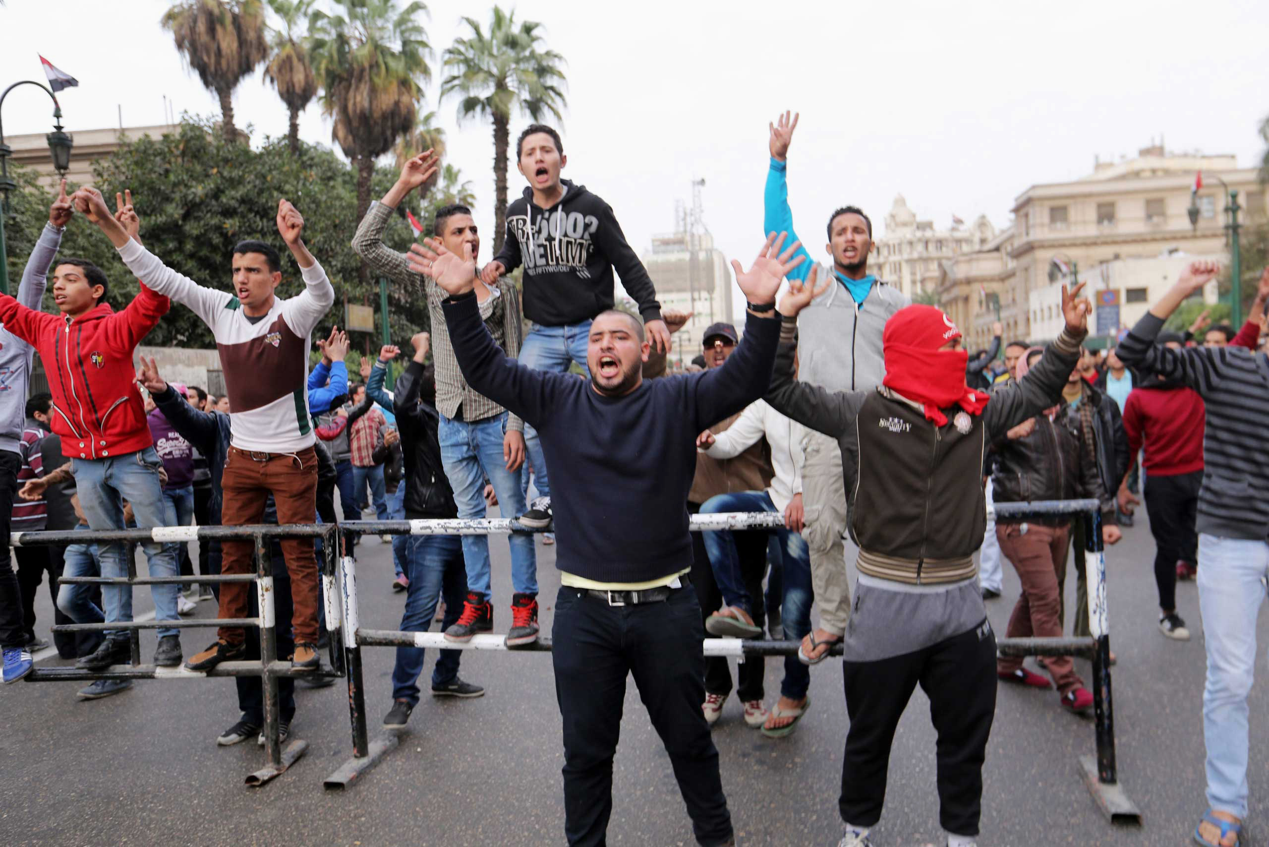 Anti-government protesters shout during demonstrations in downtown Cairo, Jan. 25, 2015.