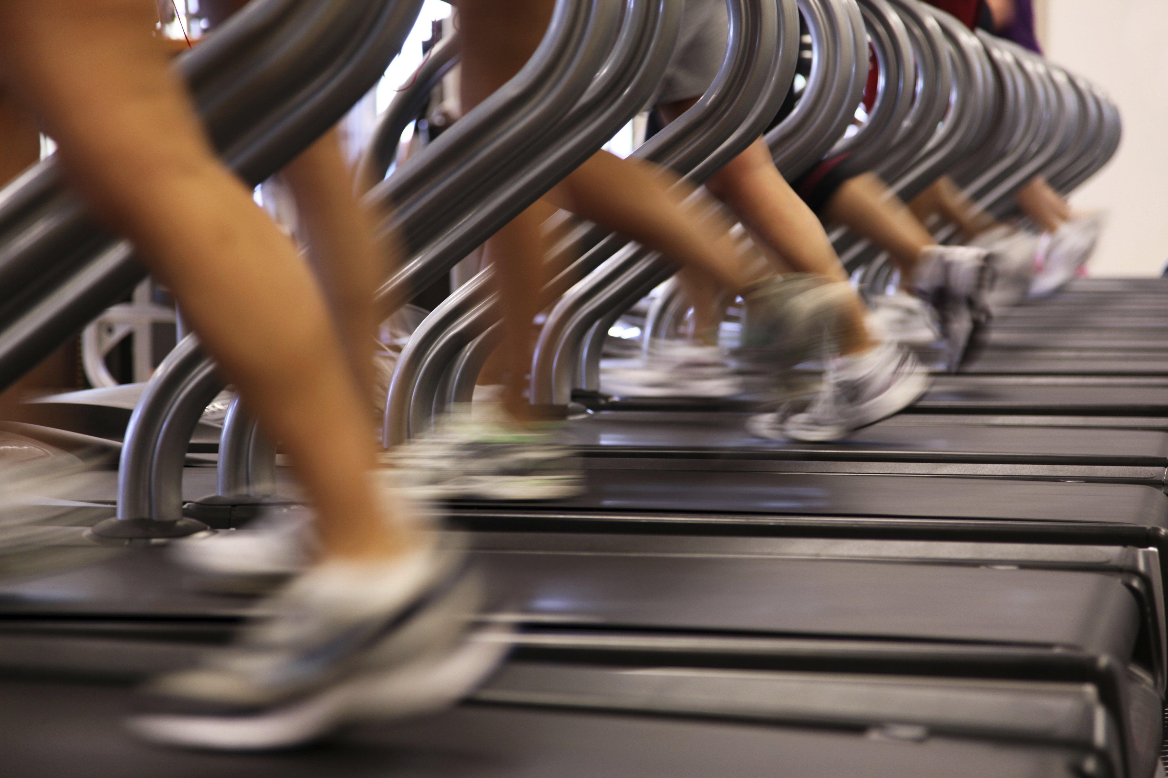 People Running Jogging on Treadmill at Health Club Gym