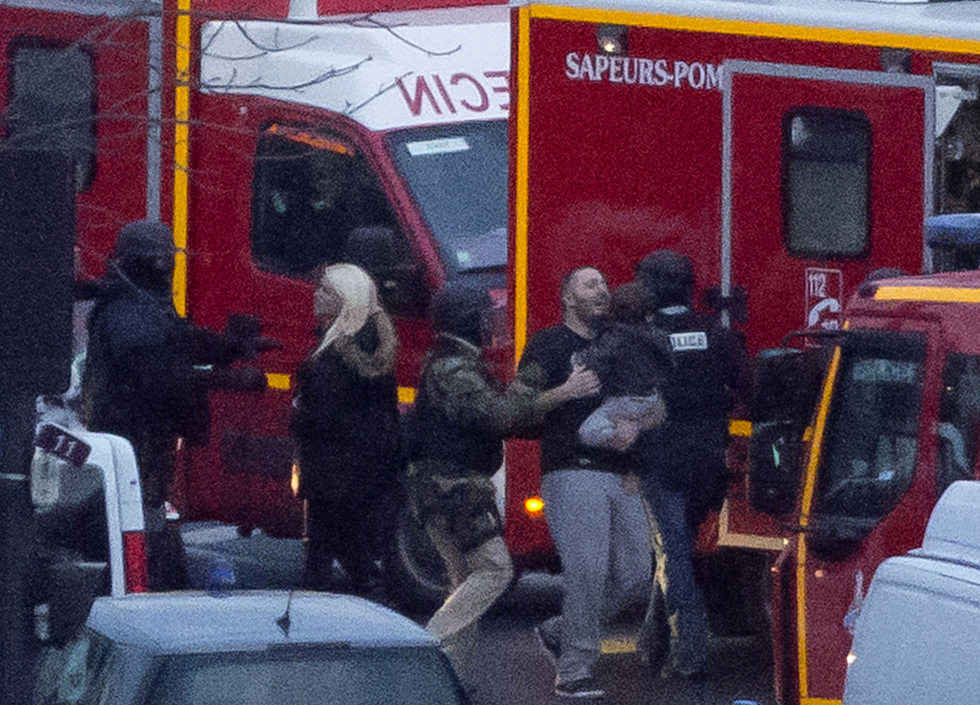 This is a Friday, Jan. 9, 2015 file photo of a security officer directs released hostages after they stormed a kosher market to end a hostage situation, Paris. Explosions and gunshots were heard as police forces stormed a kosher grocery in Paris where a gunman was holding at least five people hostage. At the kosher supermarket in Paris, a quick-thinking Muslim employee hides several Jewish shoppers in the basement before sneaking out to brief police on the hostage-taker upstairs. (AP Photo/Michel Euler, File) (Michel Euler—AP)