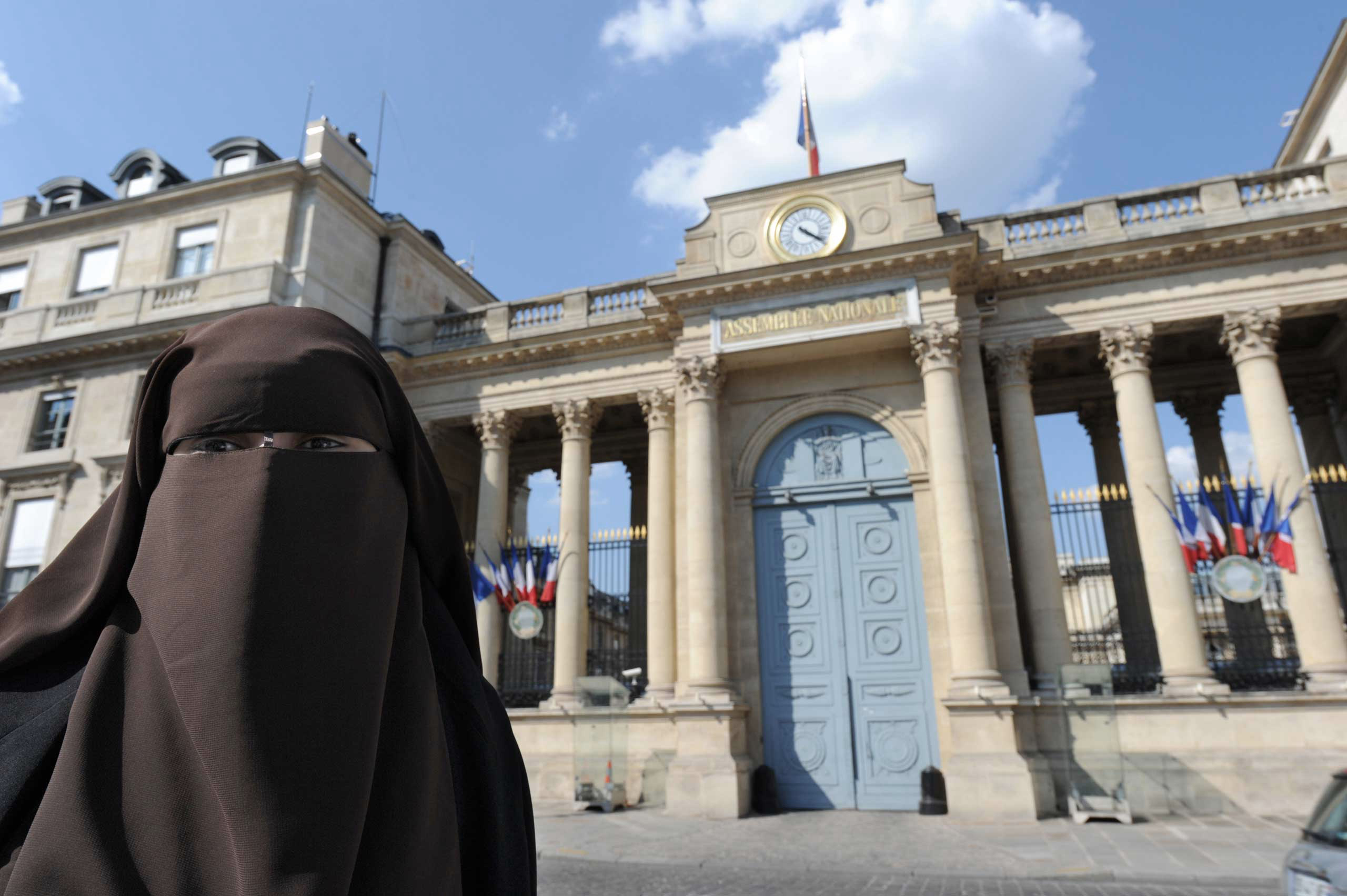 A woman poses in front of the French National Assembly to protest against ban on wearing full-face niqab veils in public, in Paris in 2011. (Mehdi Fedouach—AFP/Getty Images)