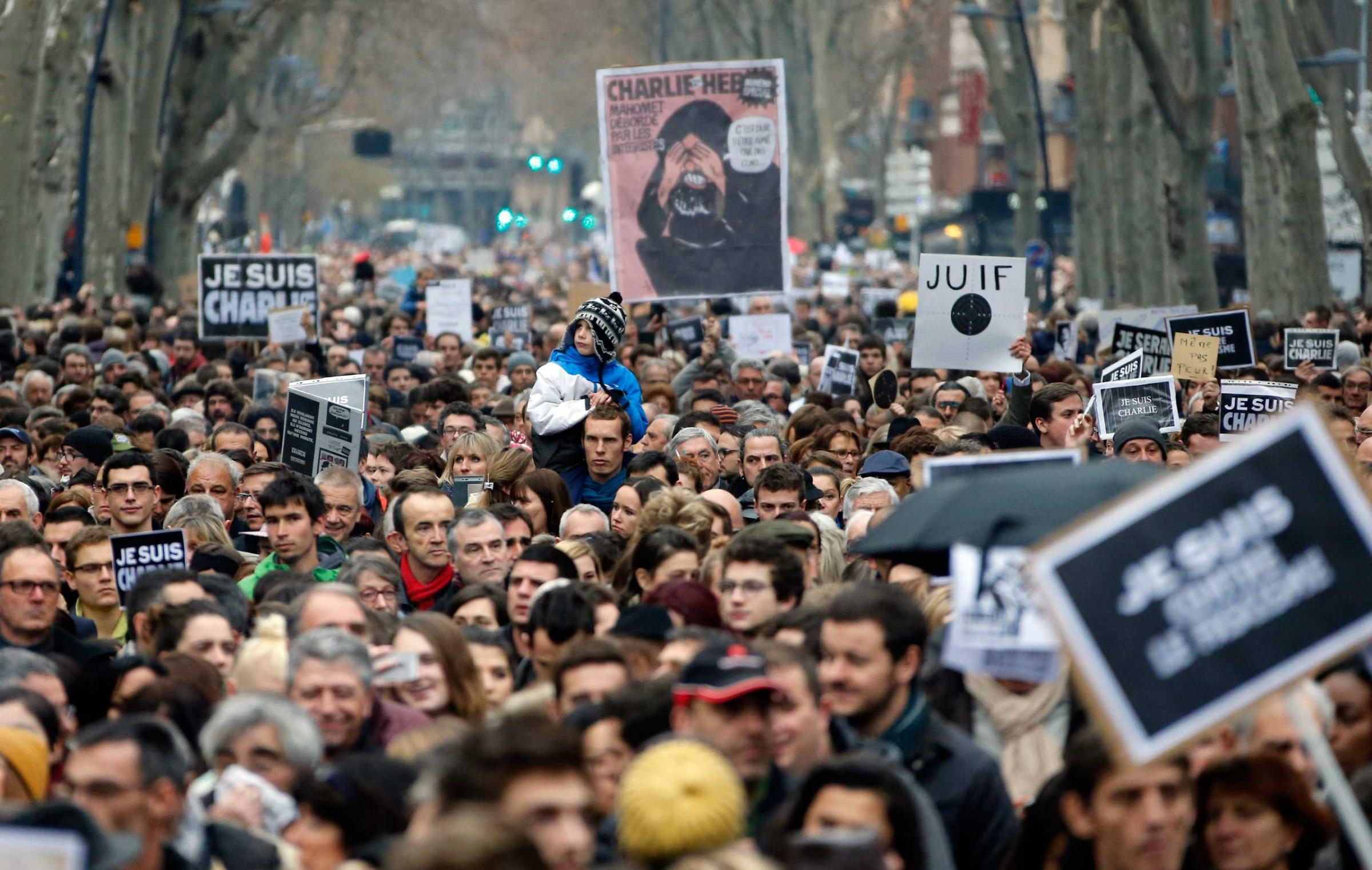 Thousands peoples walks during a tribute to the victims of the attack on the Paris headquarters of French satirical magazine Charlie Hebdo, in Toulouse, Jan. 10, 2014.