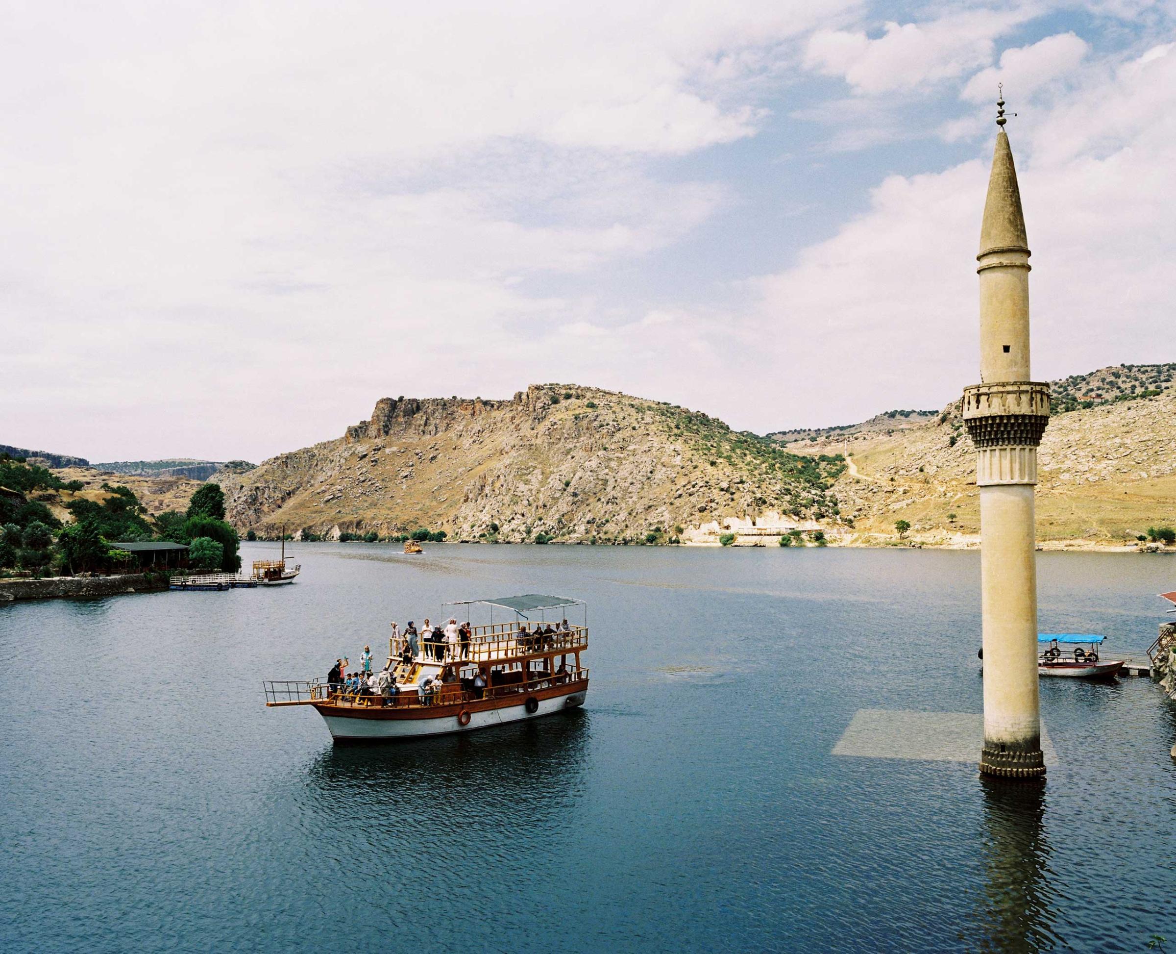 Most of the villages were submerged in the 1990s under the waters behind the dam on the Euphrates at Birecik. The town was therefore removed to the village of Karaotlak, the building of the new town is now complete. A tourist boat tour is visiting the former Savaçan Village flooded by the reservoir lake of the Birecik Dam on the Euphrates river. Turkey