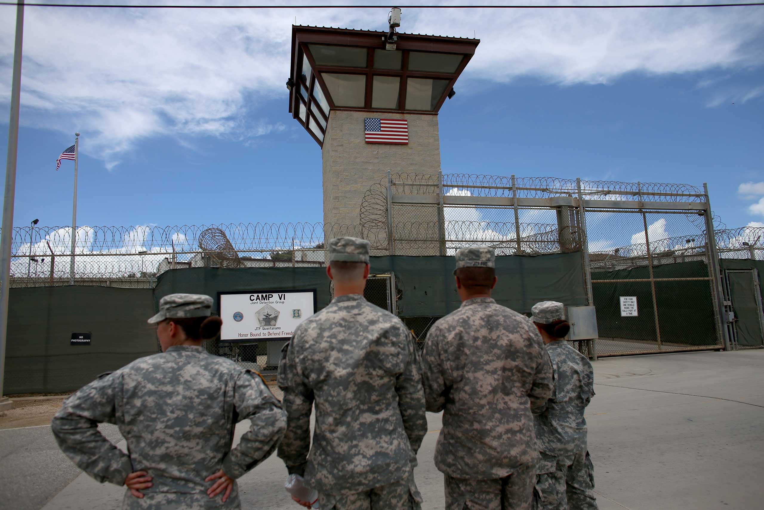 Military officers stand at the entrance to Camp VI and V at the U.S. military prison for 'enemy combatants' on June 25, 2013 in Guantanamo Bay, Cuba. (Joe Raedle—Getty Images)
