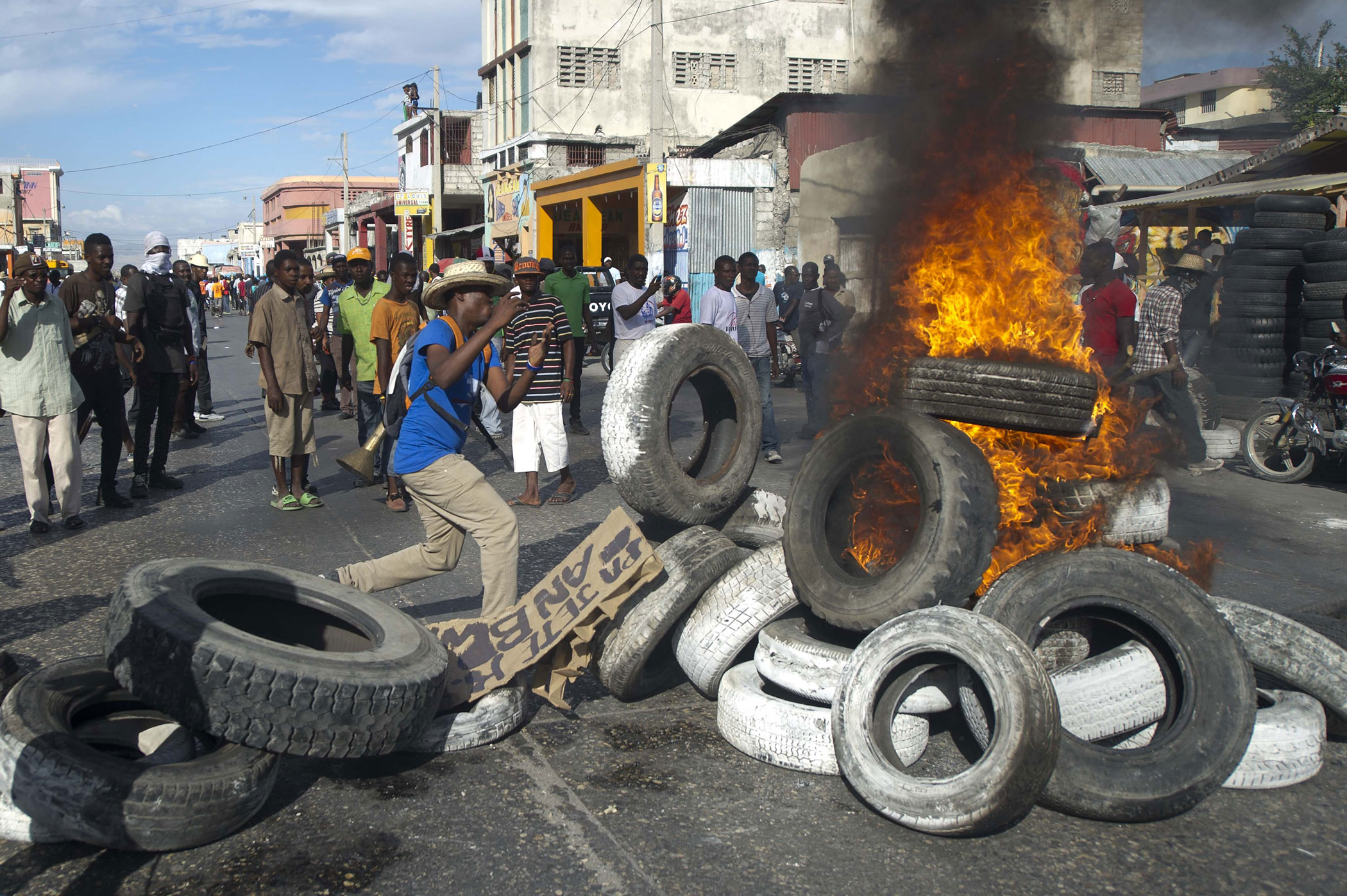 Protesters burn tires during a march against the government of Haitian President Michel Martelly in Port-au-Prince, Haiti on Jan. 11, 2015. (Hector Retamal—AFP/Getty Images)