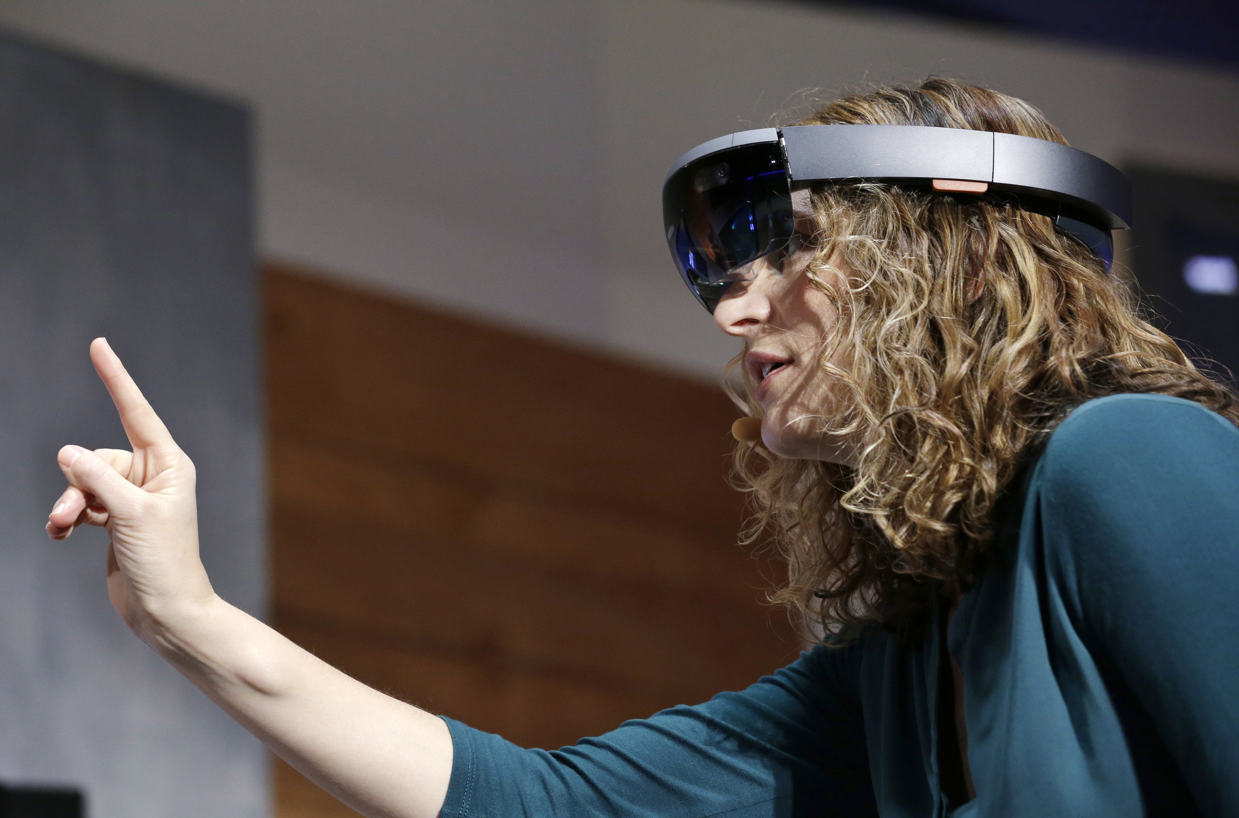 Microsoft's Lorraine Bardeen demonstrates HoloLens headset during an event at the company's headquarters in Redmond, Wash. on Jan. 21, 2015.