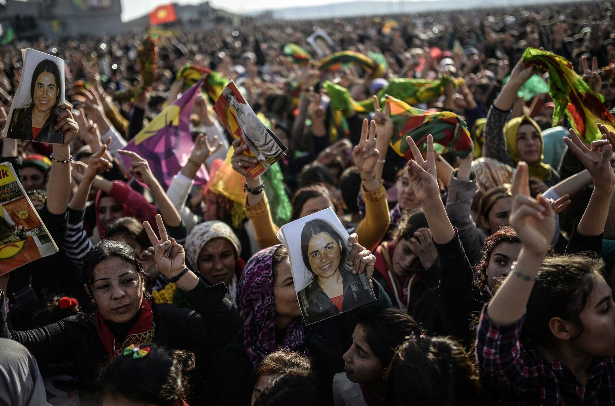Kurdish people hold a picture of a fighter during a celebration rally near the Turkish-Syrian border at Suruc, Turkey on Jan. 27, 2015. The fighter was killed in battle with Islamic state militants in Kobani.