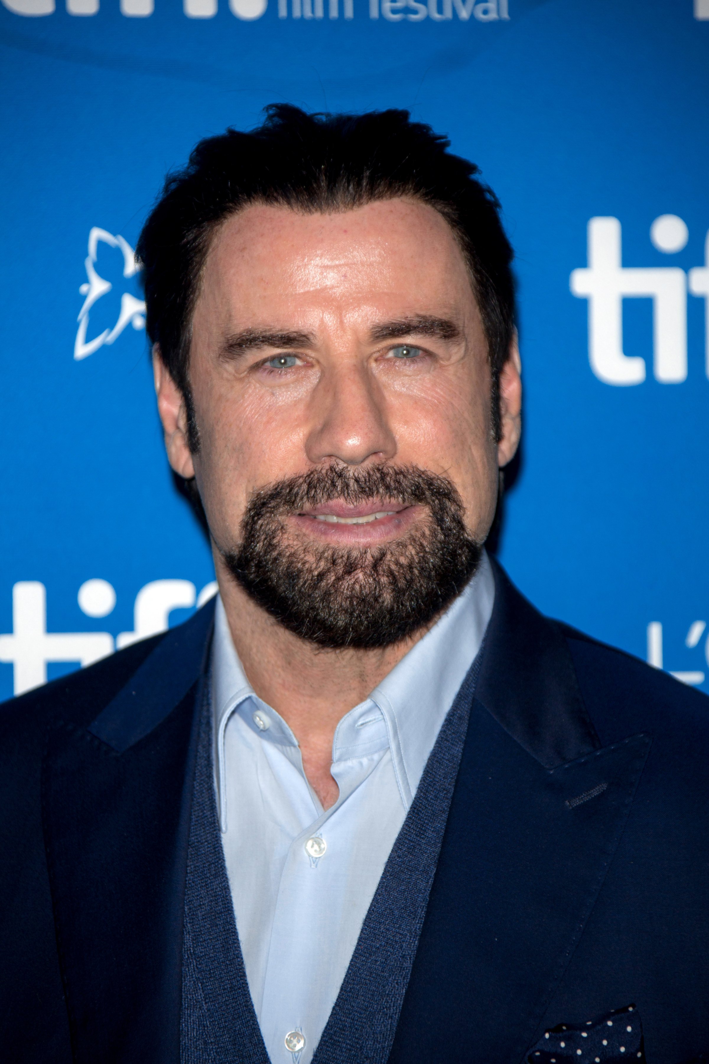 Actor John Travolta poses at the photocall of "The Forger" during the 39th Toronto International Film Festival (TIFF) in Toronto, Canada on Sept. 12, 2014.