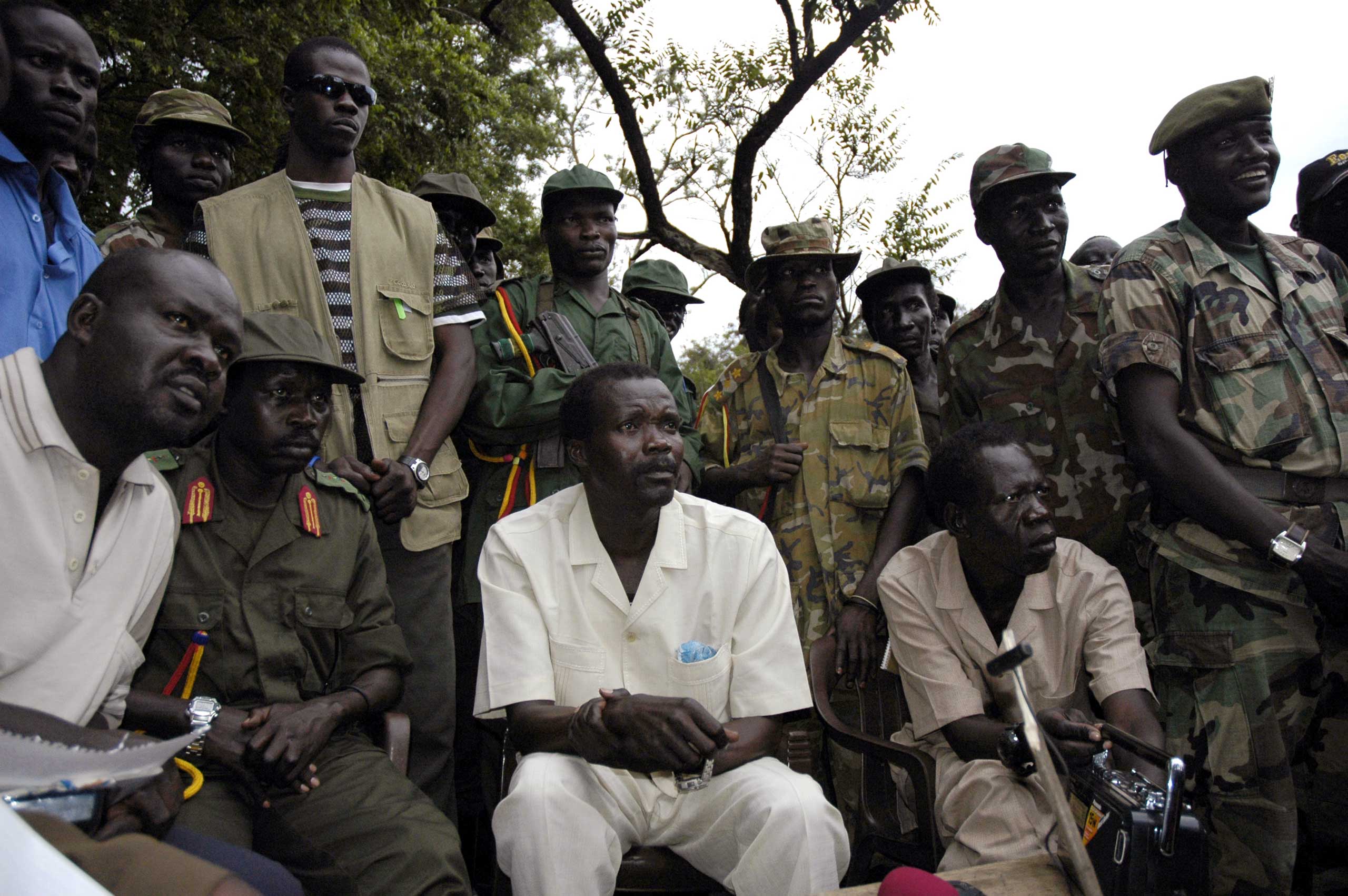 The leader of Uganda's Lord's Resistance Army rebels Joseph Kony (seated C), surrounded by his officers, addresses his first news conference in 20 years of rebellion in Nabanga, Sudan, on Aug. 1, 2006.