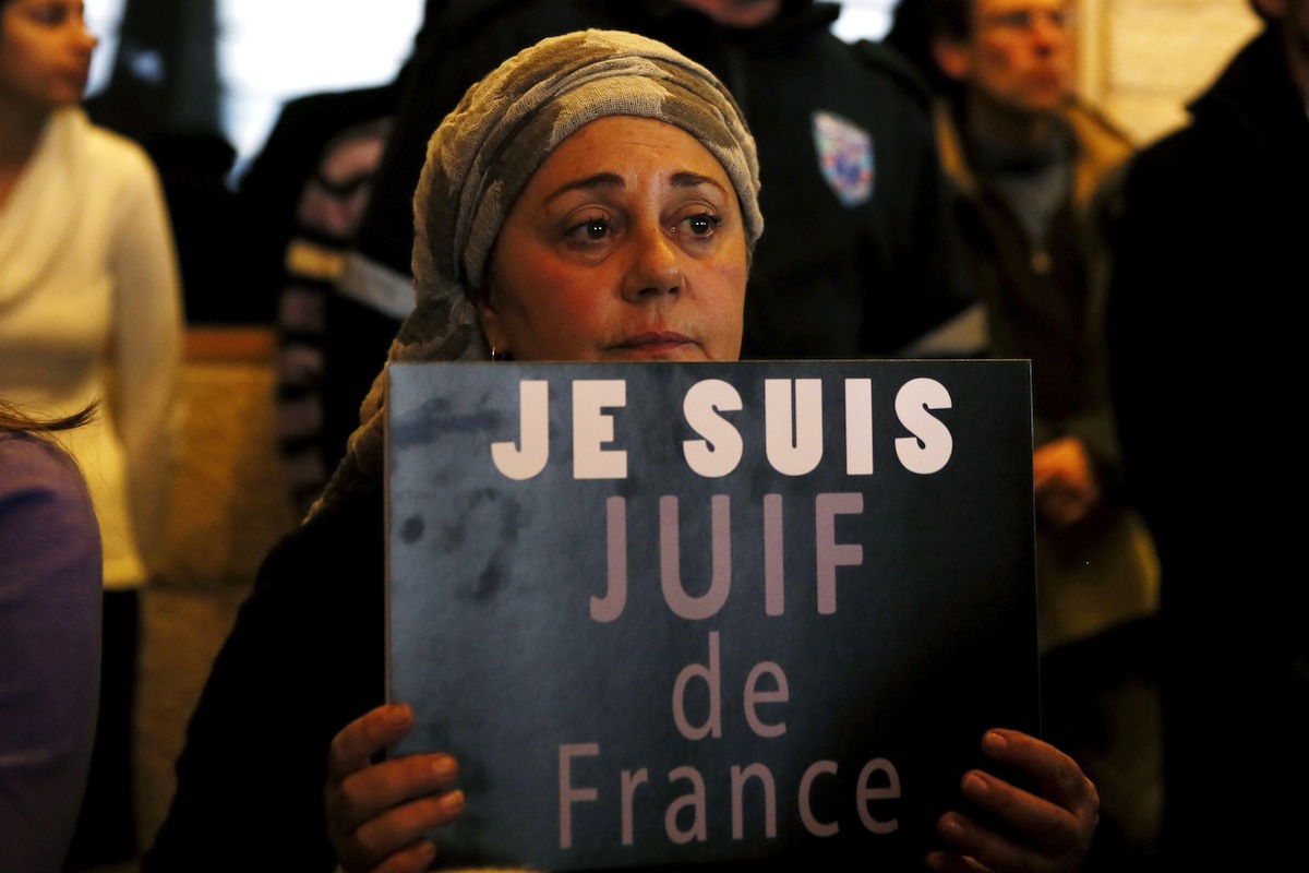 A member of the French Jewish community holds a sign during a rally in Jerusalem on Jan. 11, 2015, to demonstrate Jerusalem's support for France and the Jewish community there. (Gali Tibbon—AFP/Getty Images)