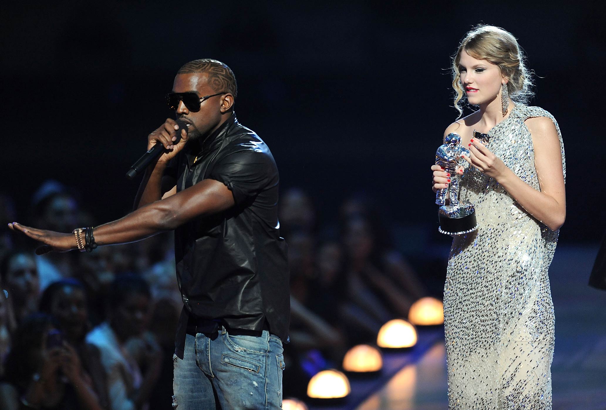 Kanye West takes the microphone from Taylor Swift and speaks onstage during the 2009 MTV Video Music Awards on Sept. 13, 2009 (Kevin Mazur—WireImage/Getty Images)