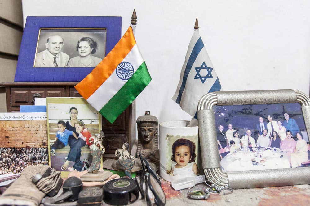 Family photographs, Indian and Israeli flags at the Cohen residence