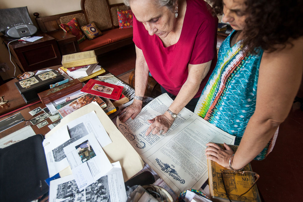 Jael Siliman (right), 58, is a former women’s studies professor at the University of Iowa and is compiling a digital archive that will preserve documents, photographs and other memorabilia from the community. She is pictured here with her mother, Flower, as they examine an old marriage certificate in August 2014.