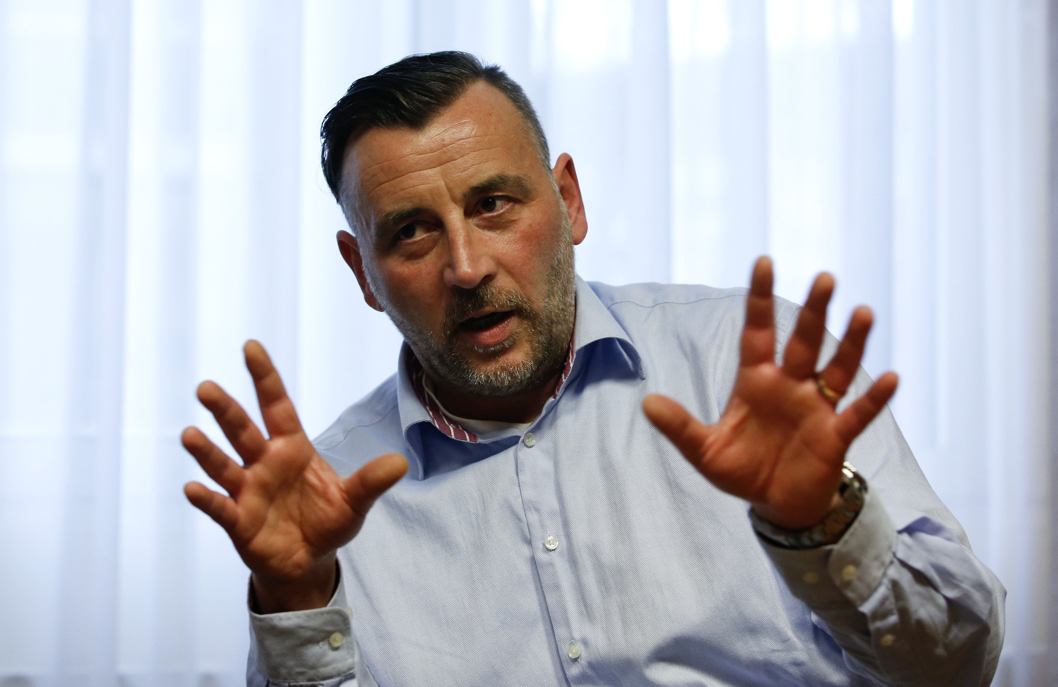 Bachmann, co-leaders of anti-immigration group PEGIDA, a German abbreviation for "Patriotic Europeans against the Islamization of the West", gestures during a Reuters interview in Dresden