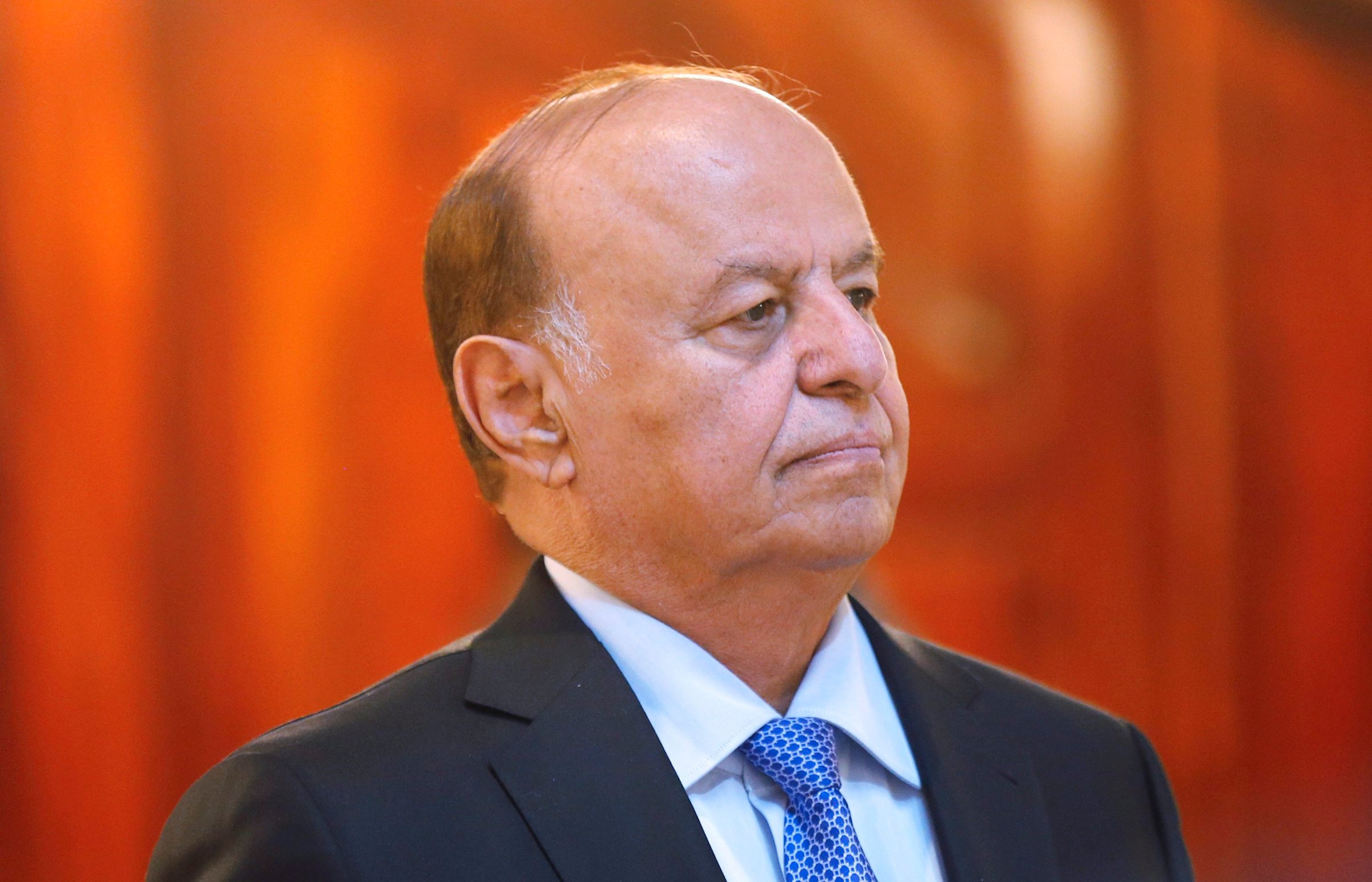 File photo of Yemen's President Hadi stands attending a reception during the holy fasting month of Ramadan at the Republican Palace in Sanaa