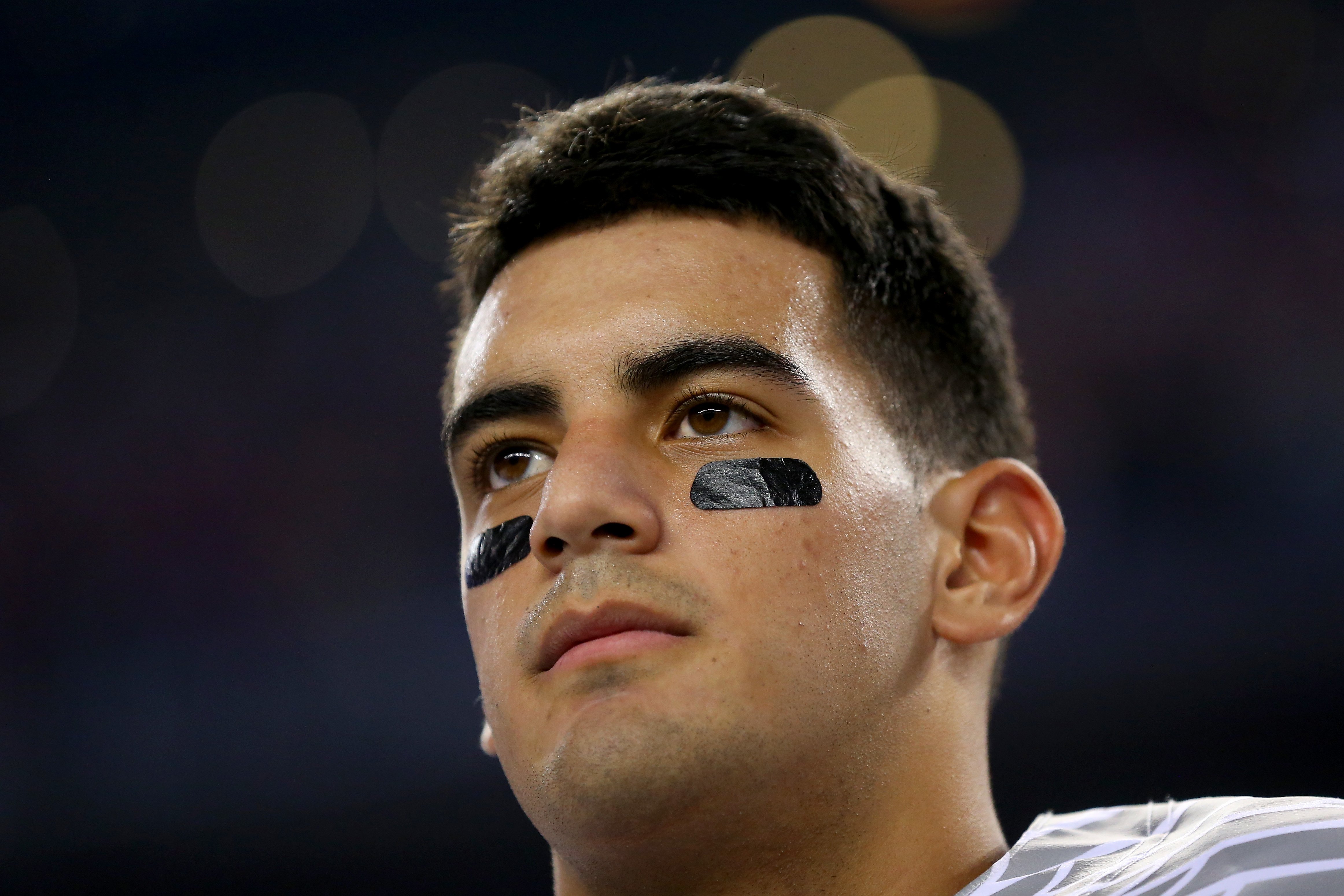 Quarterback Marcus Mariota #8 of the Oregon Ducks looks on during the national anthem before the College Football Playoff National Championship Game on Jan. 12, 2015 in Arlington, Texas. (Ronald Martinez—Getty Images)