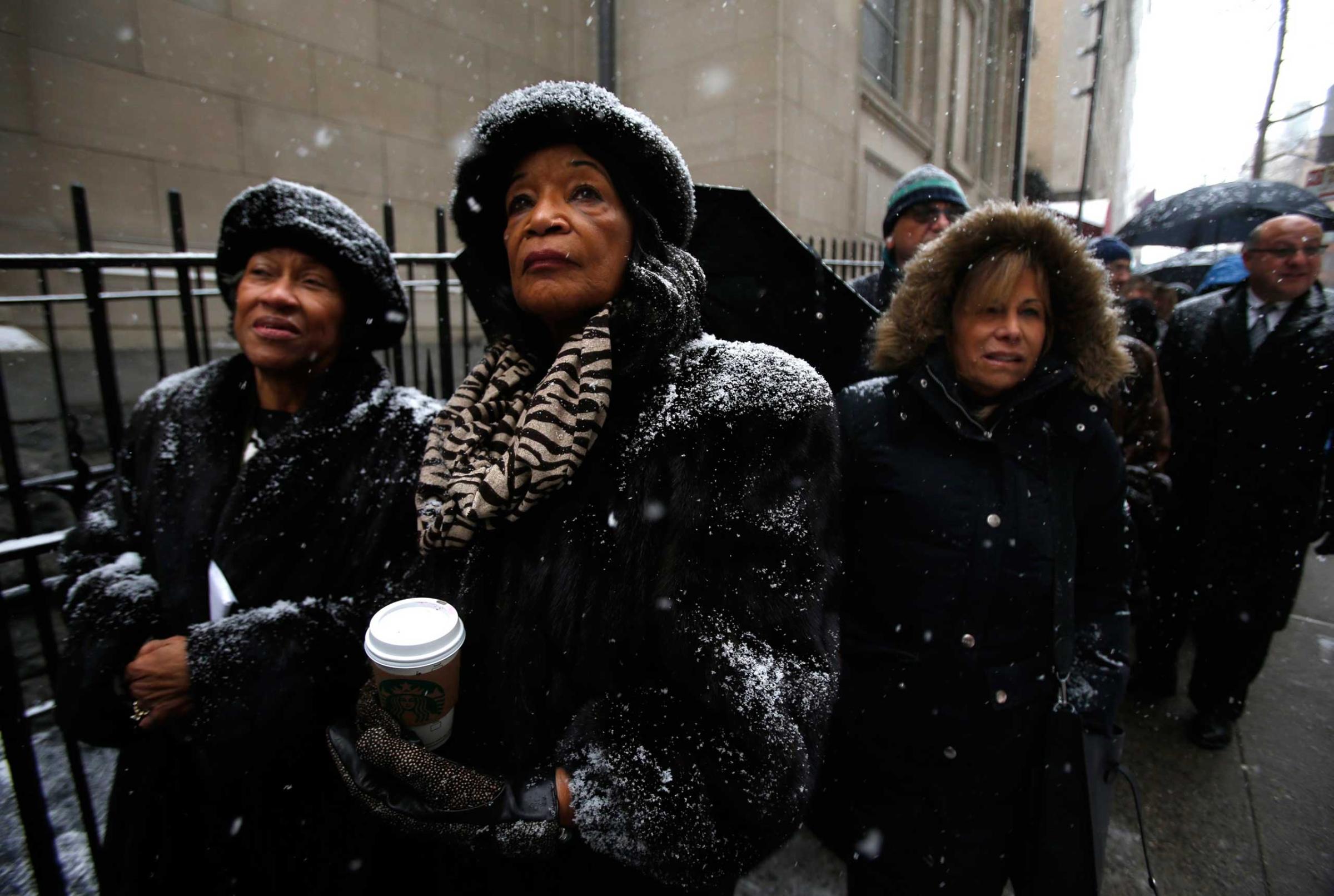Mourners wait in line in the snow to enter St. Ignatius Loyola Church, before the funeral service for former New York Governor Cuomo in New York