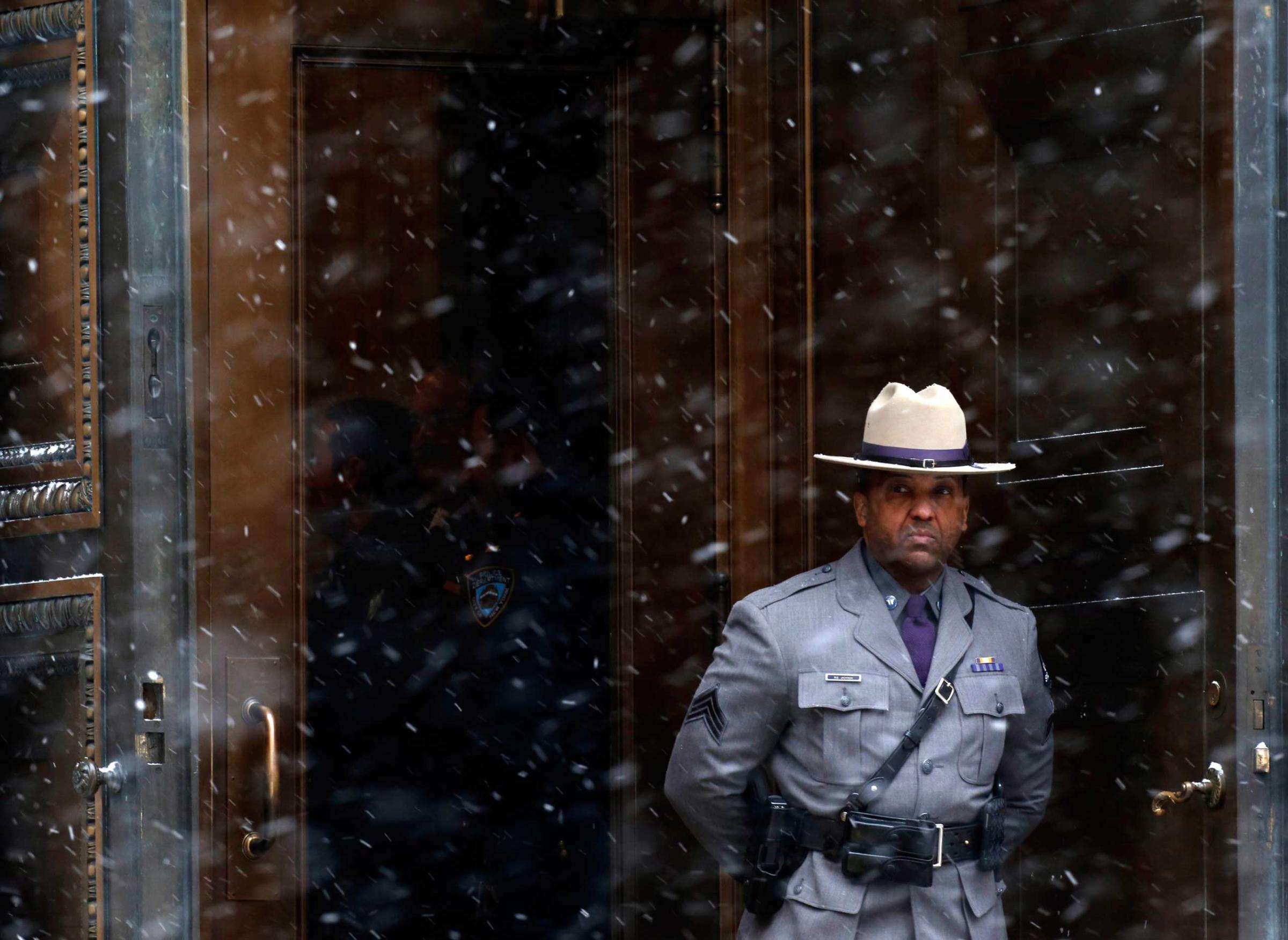 A New York State Police Trooper stands in the doorway outside St. Ignatius Loyola Church during the funeral service for former New York Governor Mario Cuomo in New York