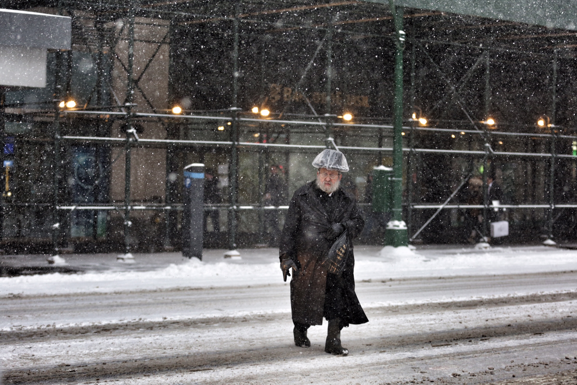 A man crosses the street during a snow storm in New York City on Jan. 26, 2015.