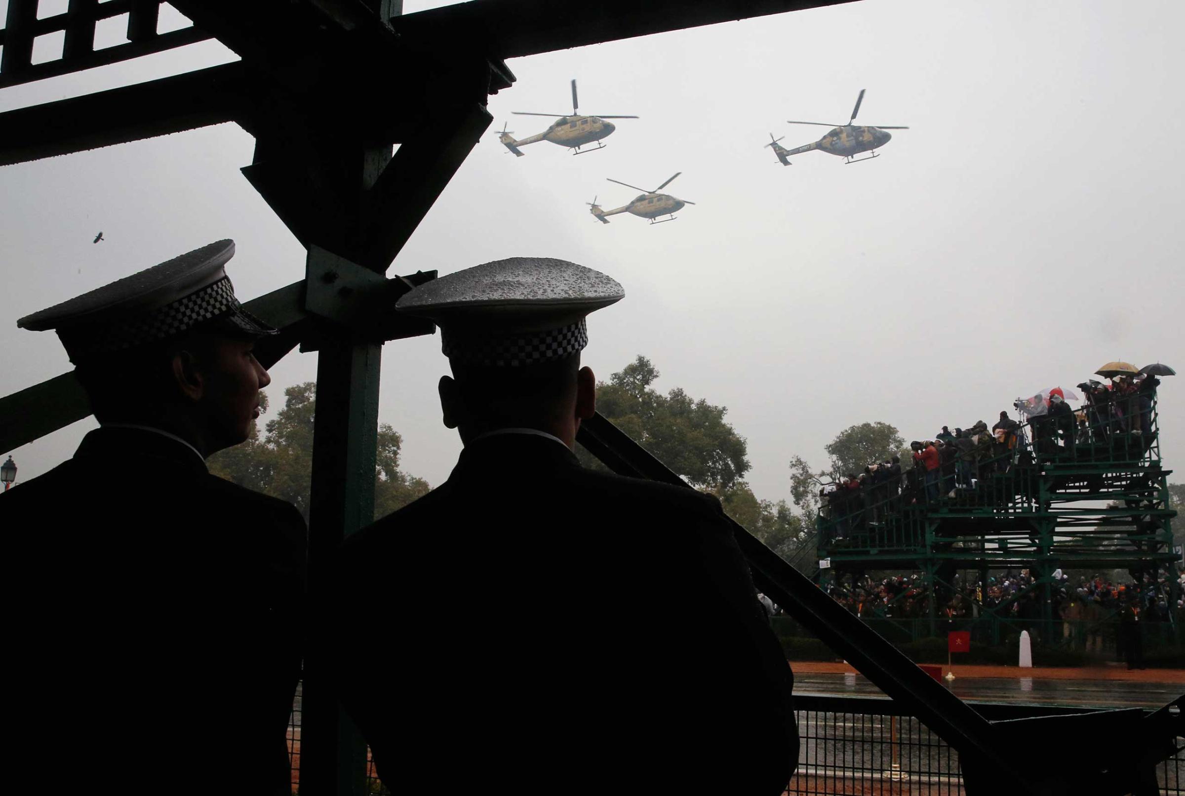 Indian Navy sailors watch military helicopters fly-by during India's Republic Day parade in New Delhi, Jan. 26, 2015.