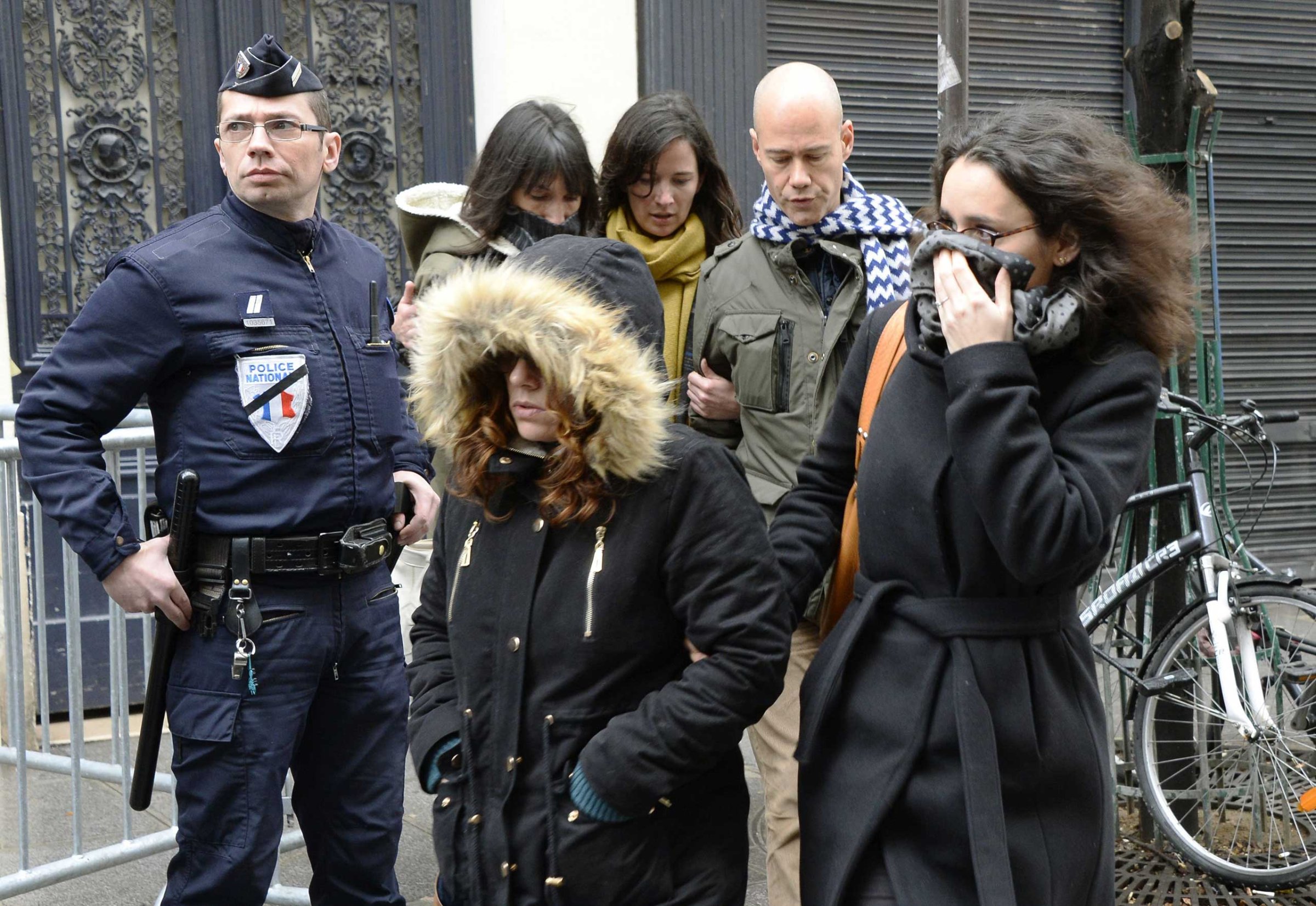 Staff arrive to attend an editorial meeting of French satirical weekly newspaper Charlie Hebdo and Liberation, Jan. 9, 2015 in Paris.