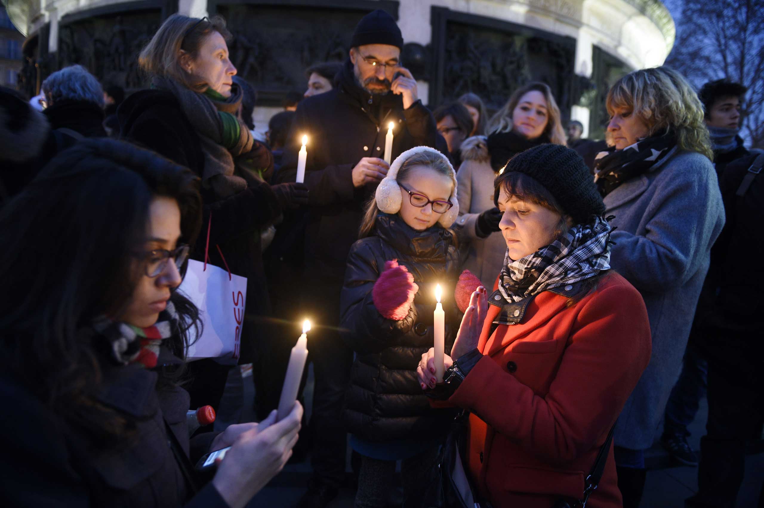 People light candles during a rally in support of the victims of the attack by gunmen at French satirical newspaper Charlie Hebdo at the Place de la Republique in Paris, on Jan. 7, 2015. (Martin Bureau—AFP/Getty Images)