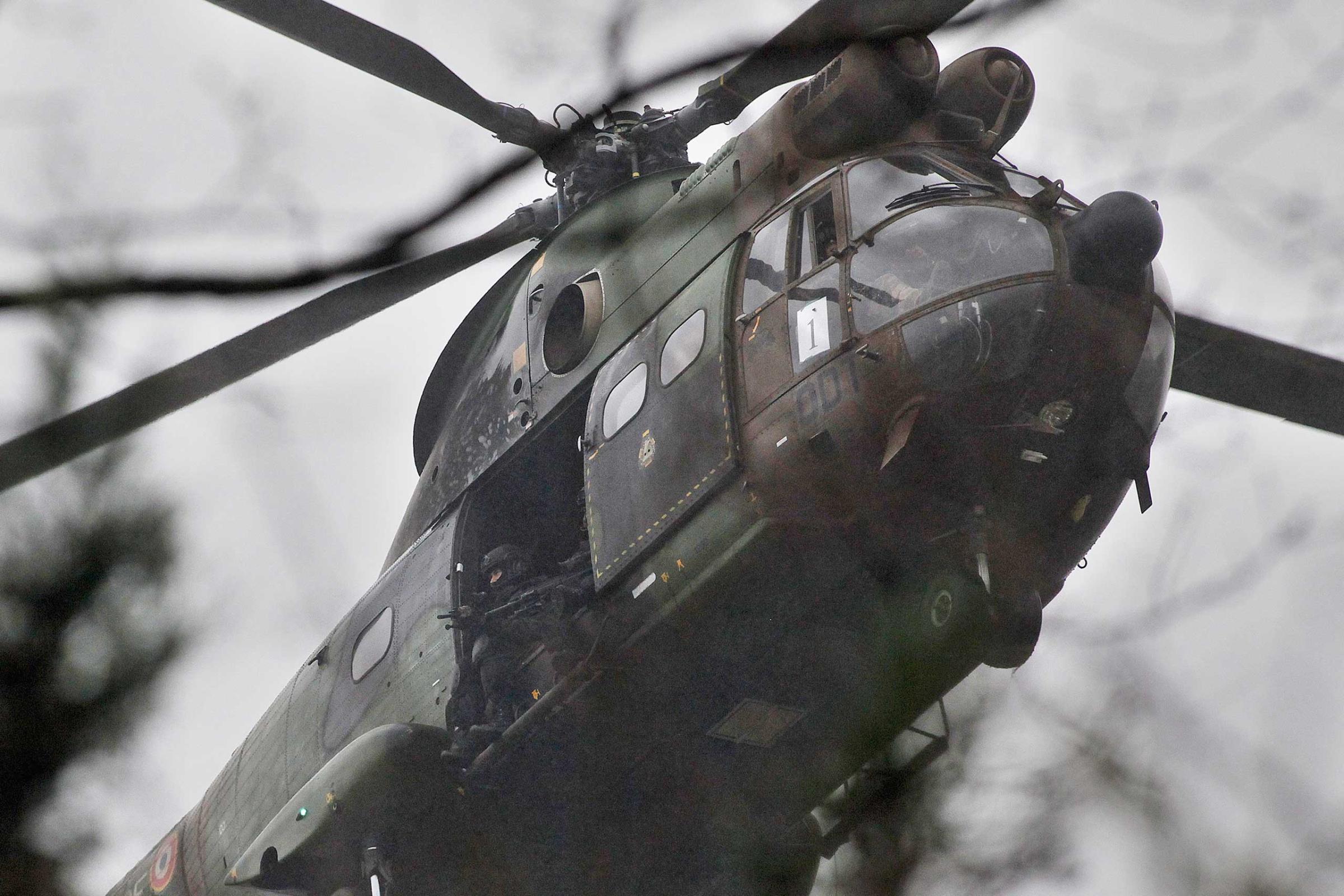 Armed security forces fly overhead in a military helicopter in Dammartin-en-Goele, northeast of Paris, Jan. 9, 2015.