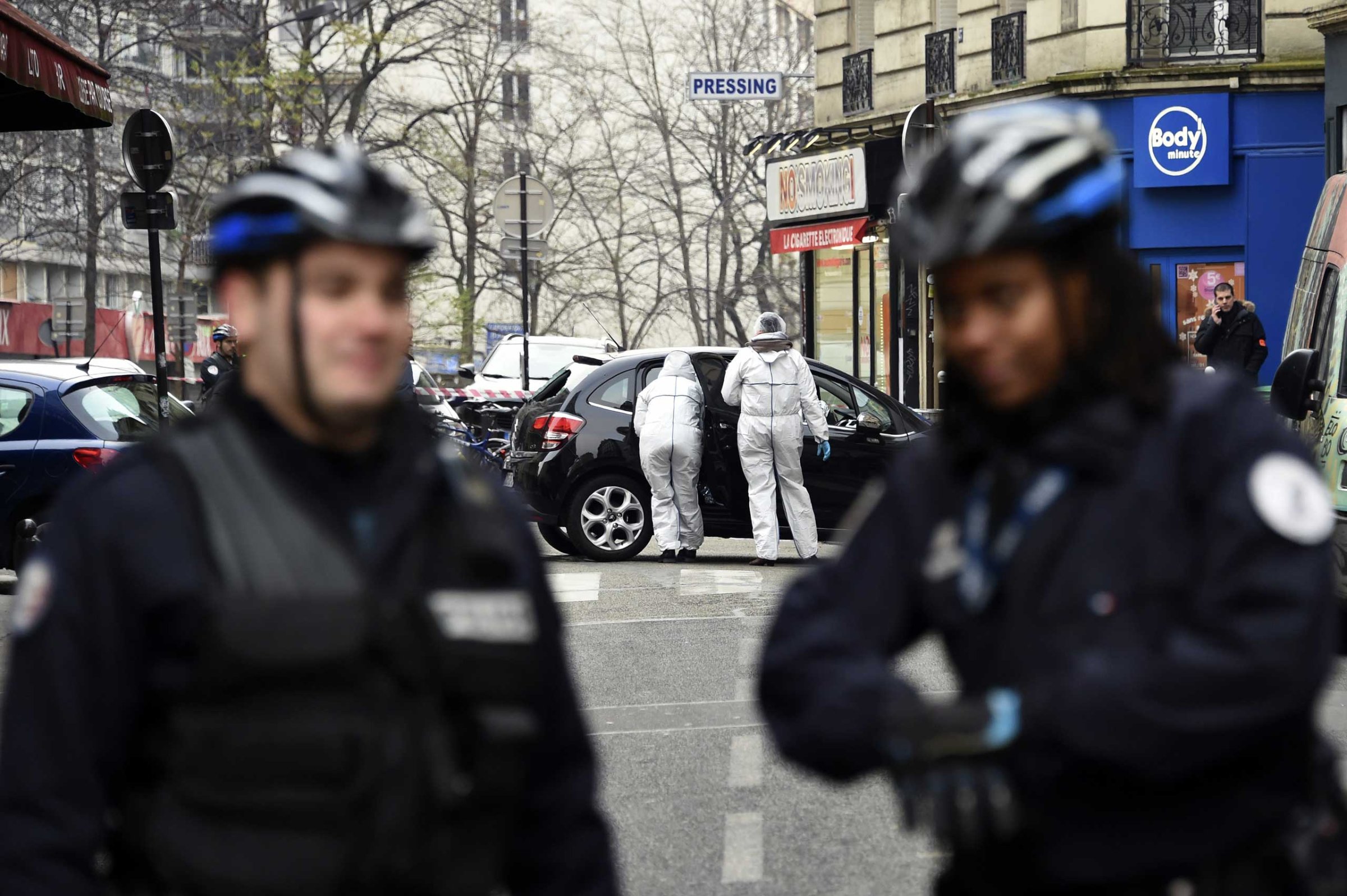 French police officers and forensic experts examine the car used by armed gunmen who stormed the Paris offices of satirical newspaper Charlie Hebdo on Jan. 7, 2015 in Paris.