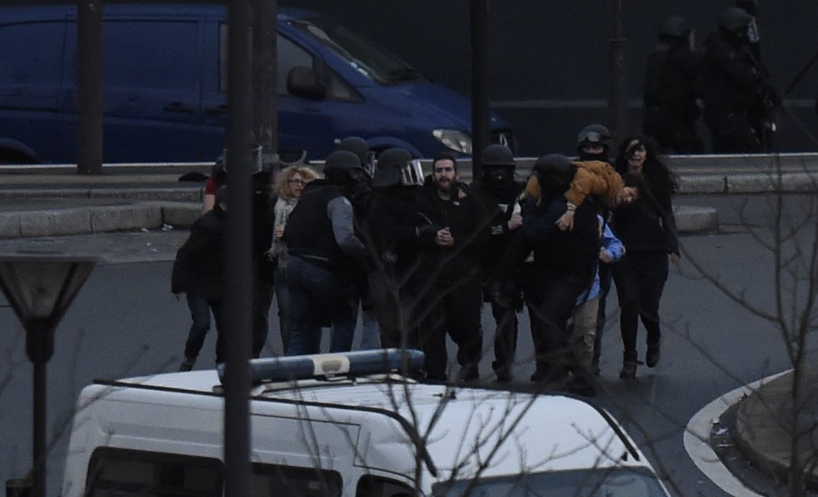 The moment when members of the French anti-terror forces RAID storm the kosher store where Amedy Coulibaly, an islamist gunman holds hostages, on Cours de Vincennes in Paris, on Jan. 9, 2015.