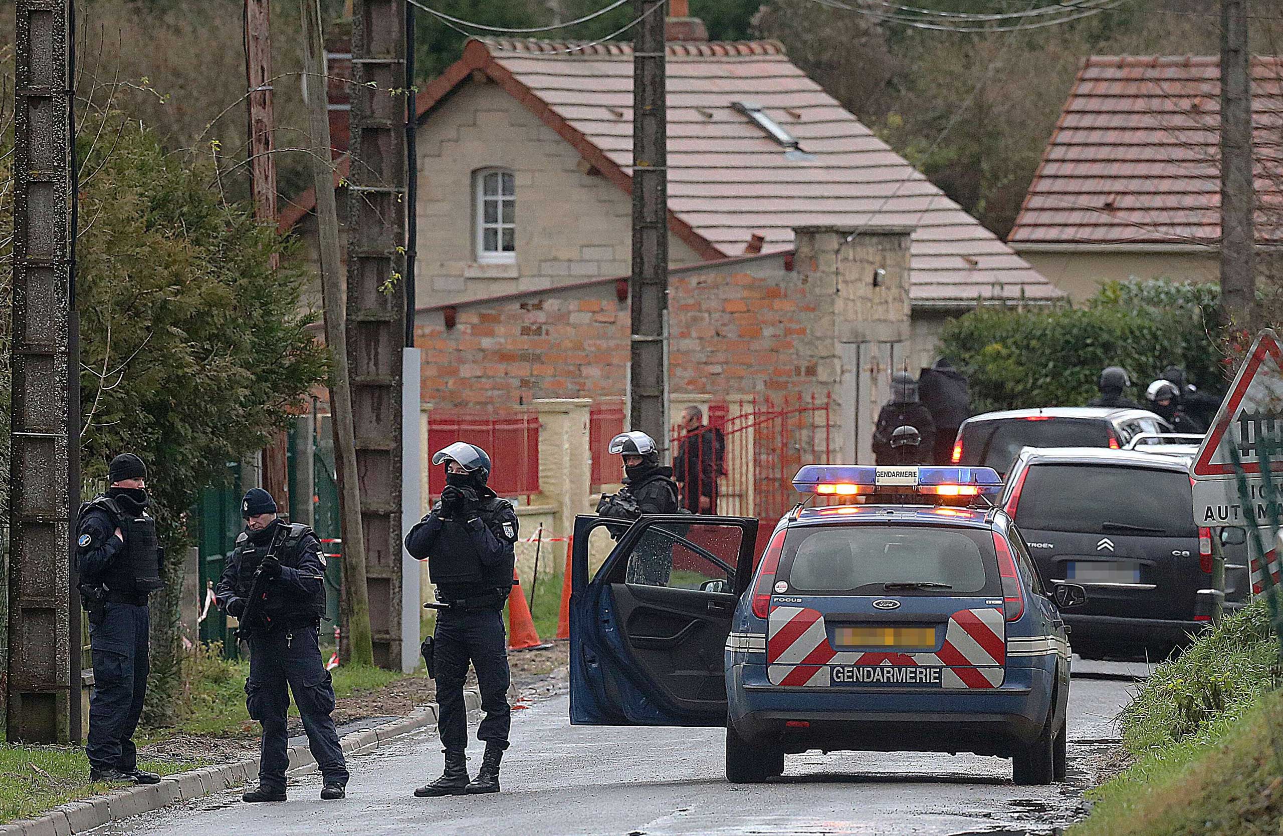 Members of GIPN and of RAID, French police special forces, are pictured in Corcy, near Villers-Cotterets, north-east of Paris, on Jan. 8, 2015, where the two armed suspects from the attack on French satirical weekly newspaper Charlie Hebdo were spotted in a gray Clio. (Francois Nascimbeni—AFP/Getty Images)