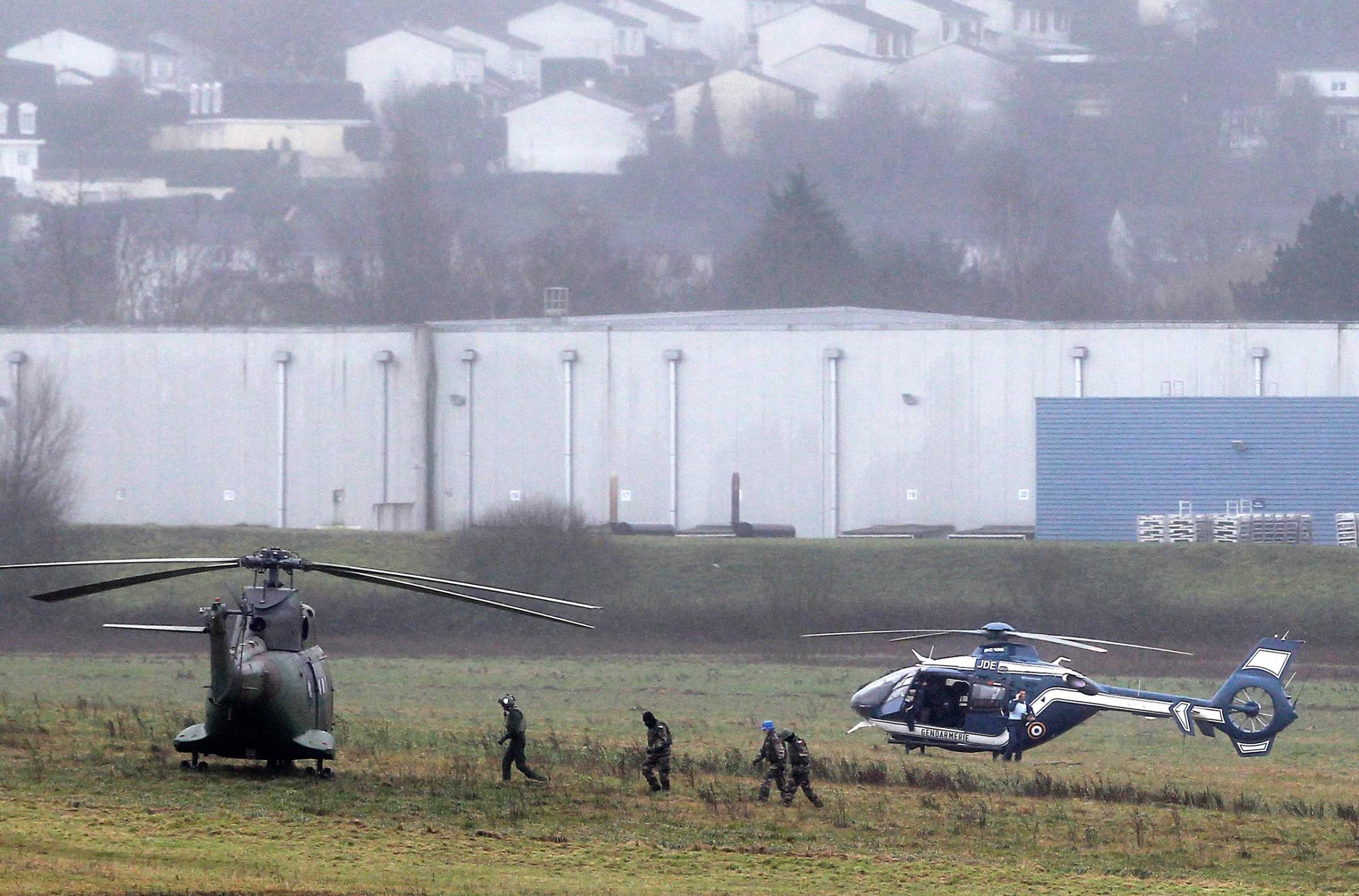 Police and army forces take positions in Dammartin-en-Goele, northeast Paris, as part of an operation to seize two heavily armed suspects, Jan. 9, 2015