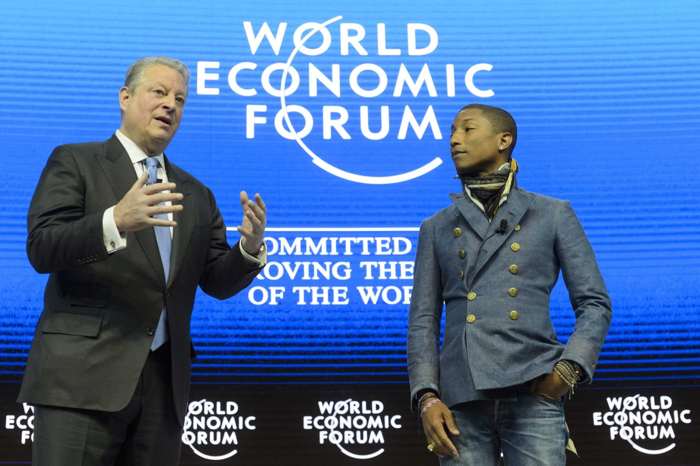 Former US Vice President Al Gore speaks next to US rapper Pharrell Williams during a panel session on the first day of the 45th Annual Meeting of the World Economic Forum, in Davos, Jan. 21, 2015.